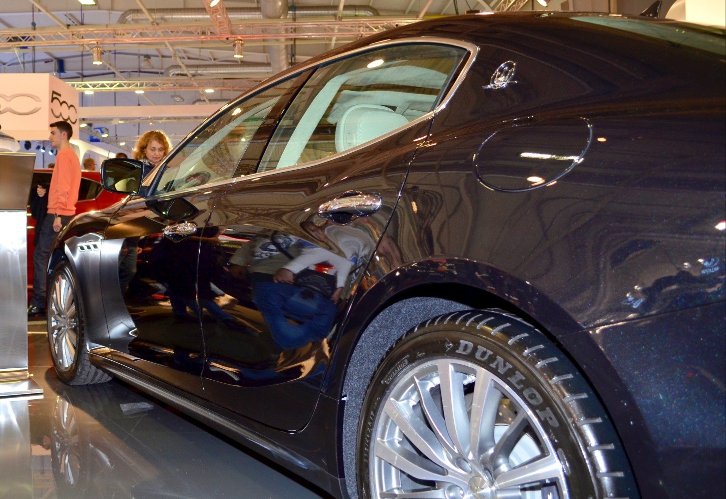 Sleek sedan side profile with rear alloy wheel and Dunlop tire
