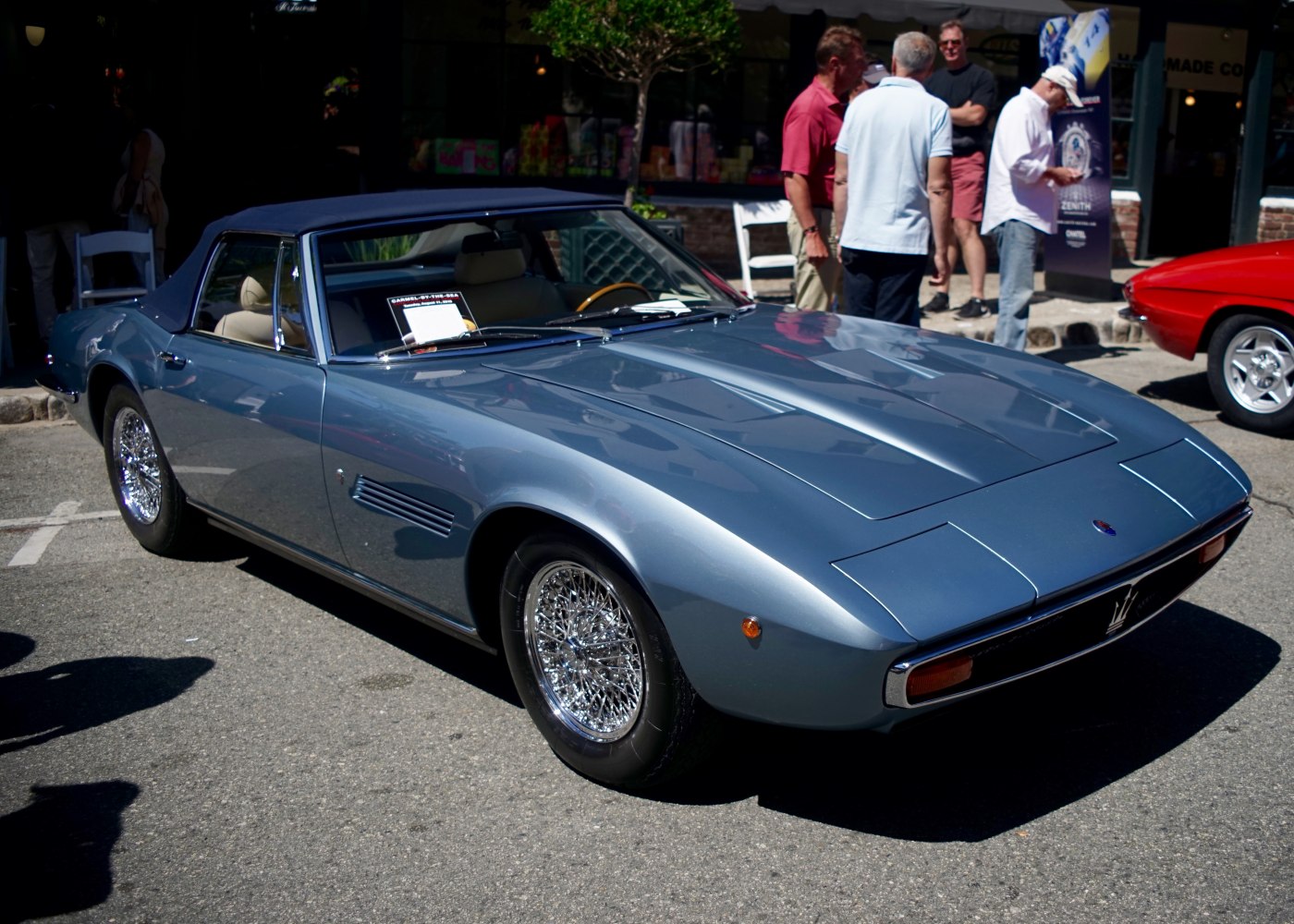 Convertible vintage sports car with sleek soft top and wire-spoke wheels