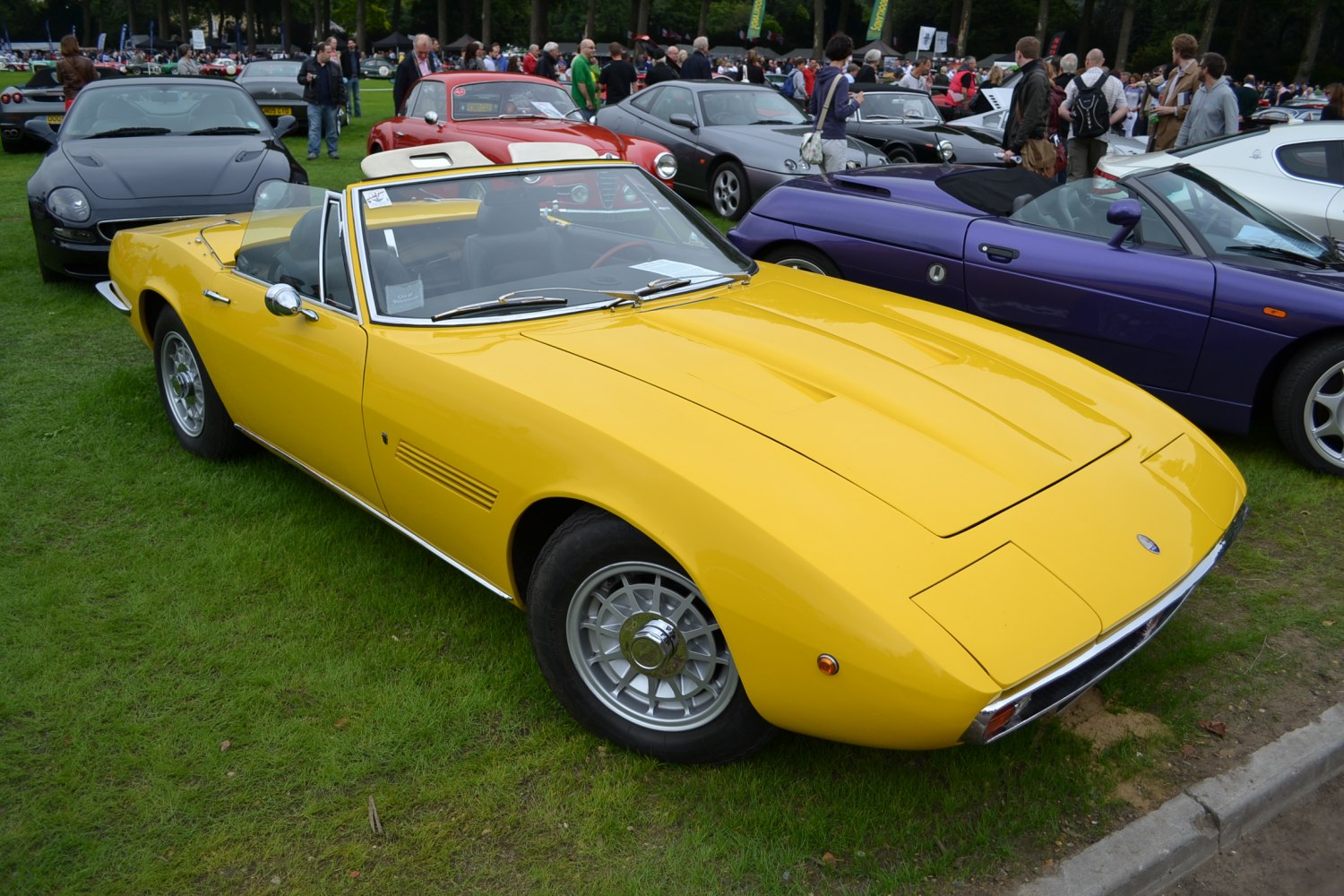 Yellow convertible with pop-up headlights and wire wheels