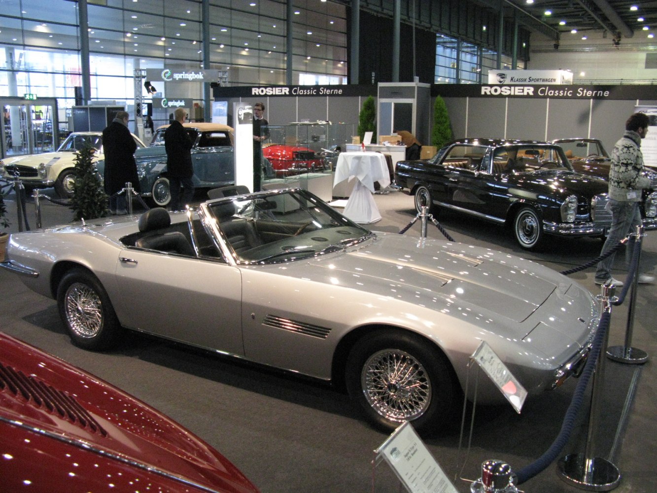 Silver convertible sports car with wire spoke wheels