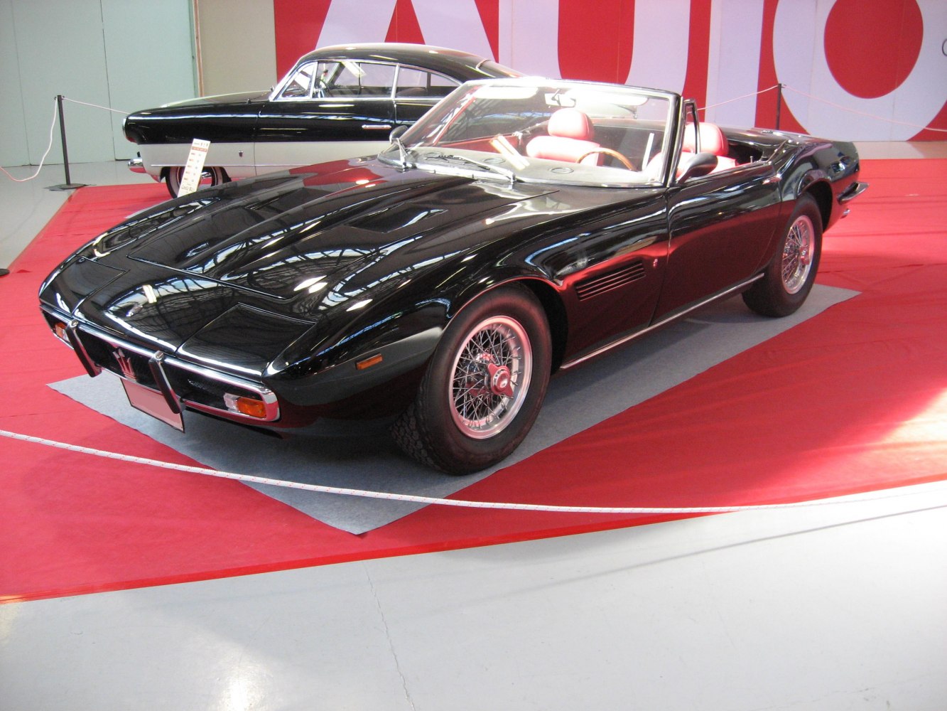 Classic black convertible with wire-spoke wheels and open roof