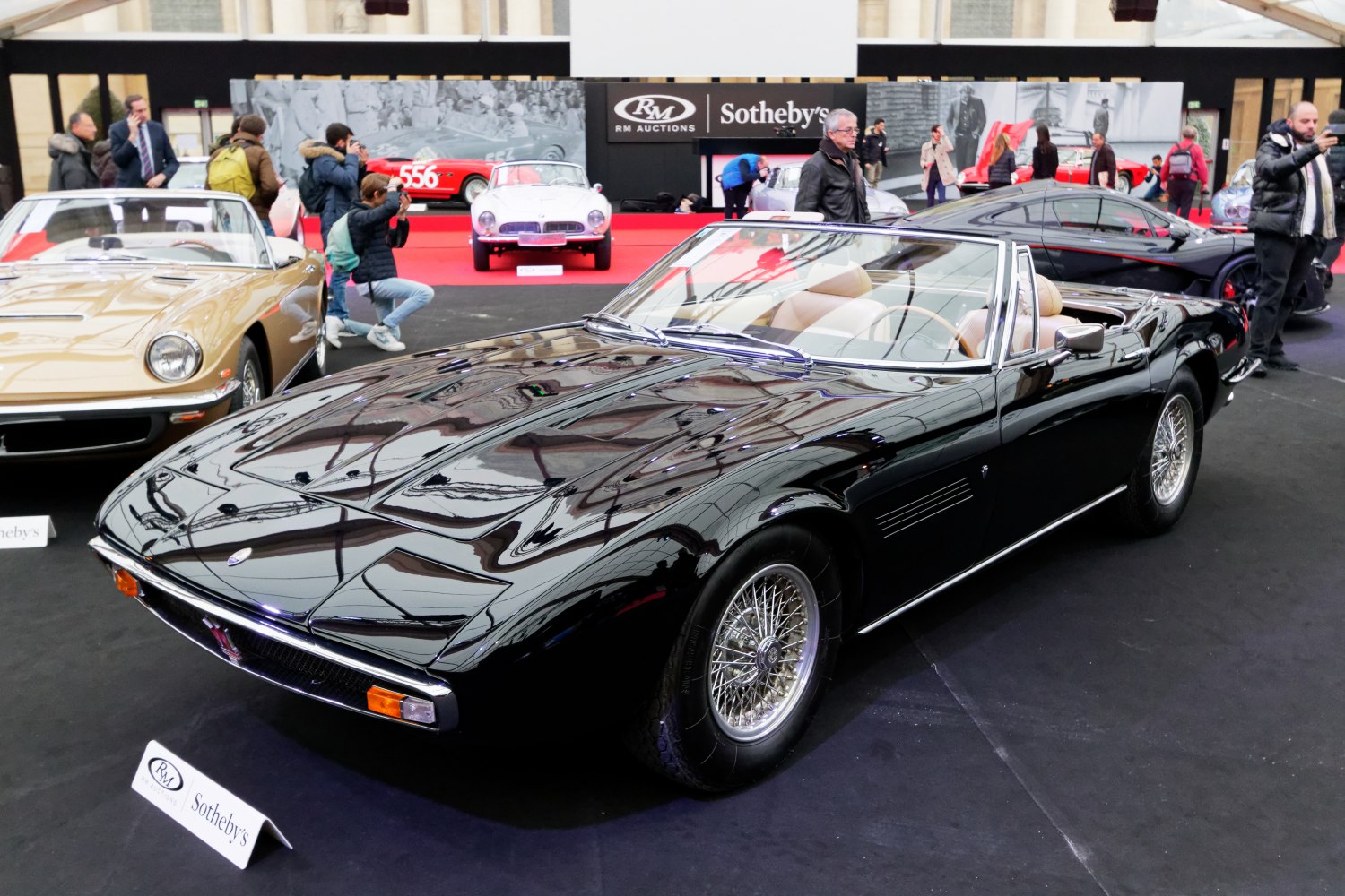 Vintage convertible with wire-spoke wheels and beige interior