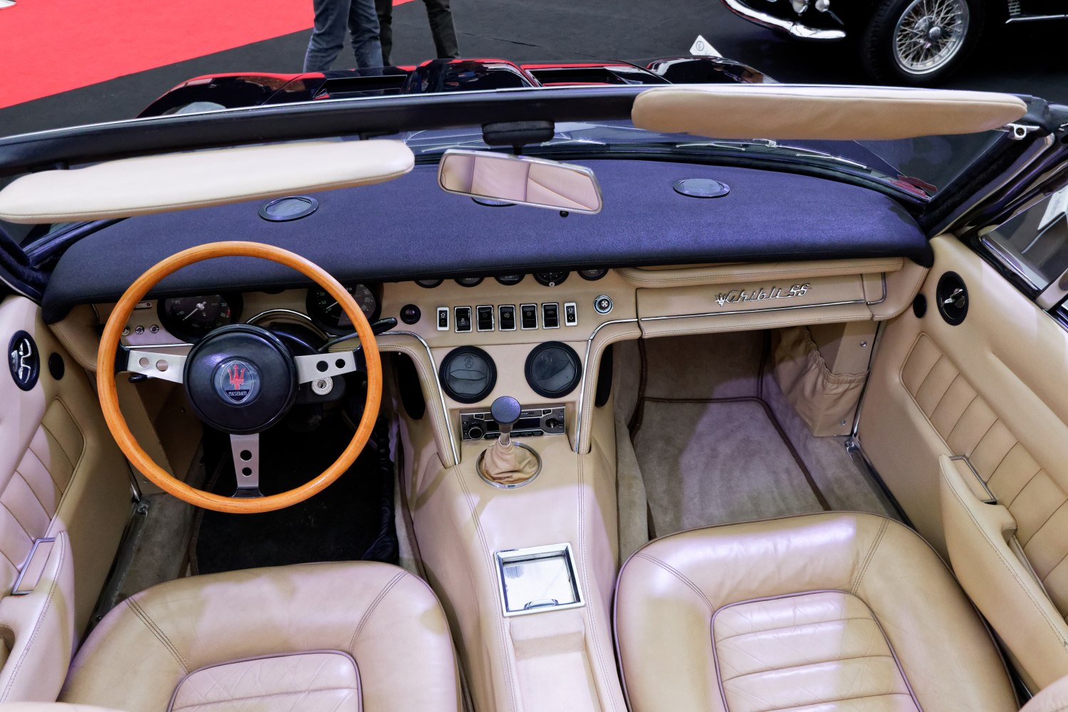 Classic vintage car interior with wooden steering wheel and analog gauges
