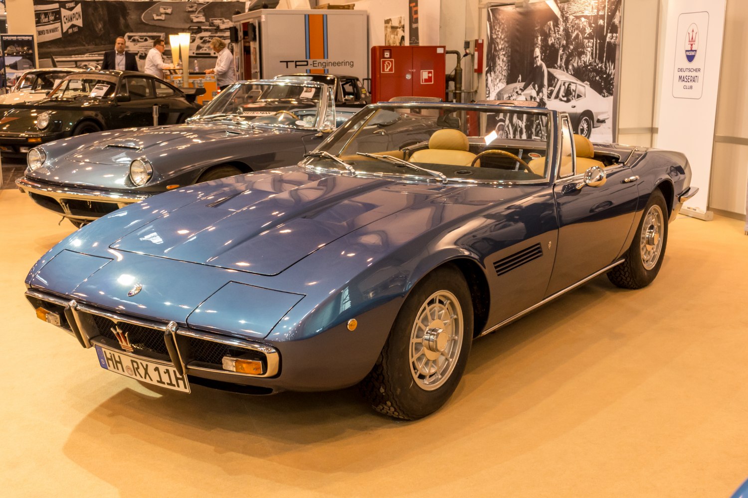 1960s convertible sports car with pop-up headlights and wire-style wheels