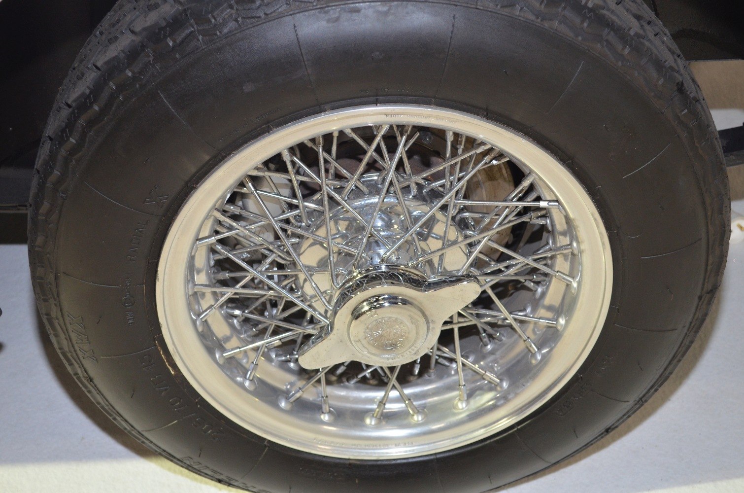 Close-up of vintage wire spoke wheel with knock-off hub.