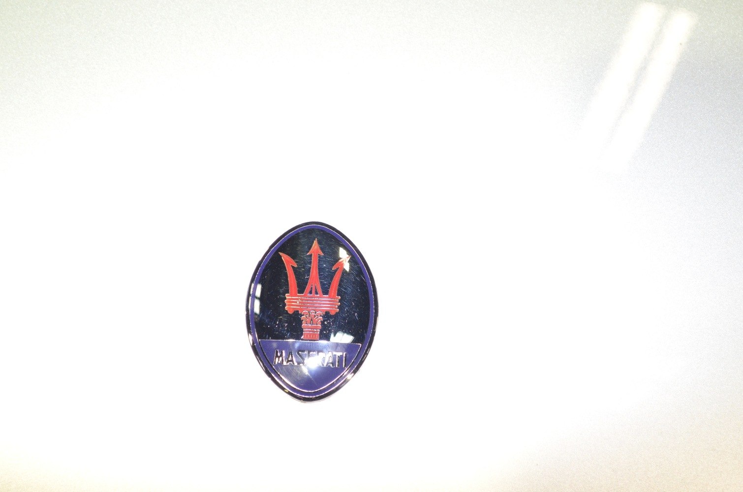 Close-up of Maserati Ghibli I trident emblem