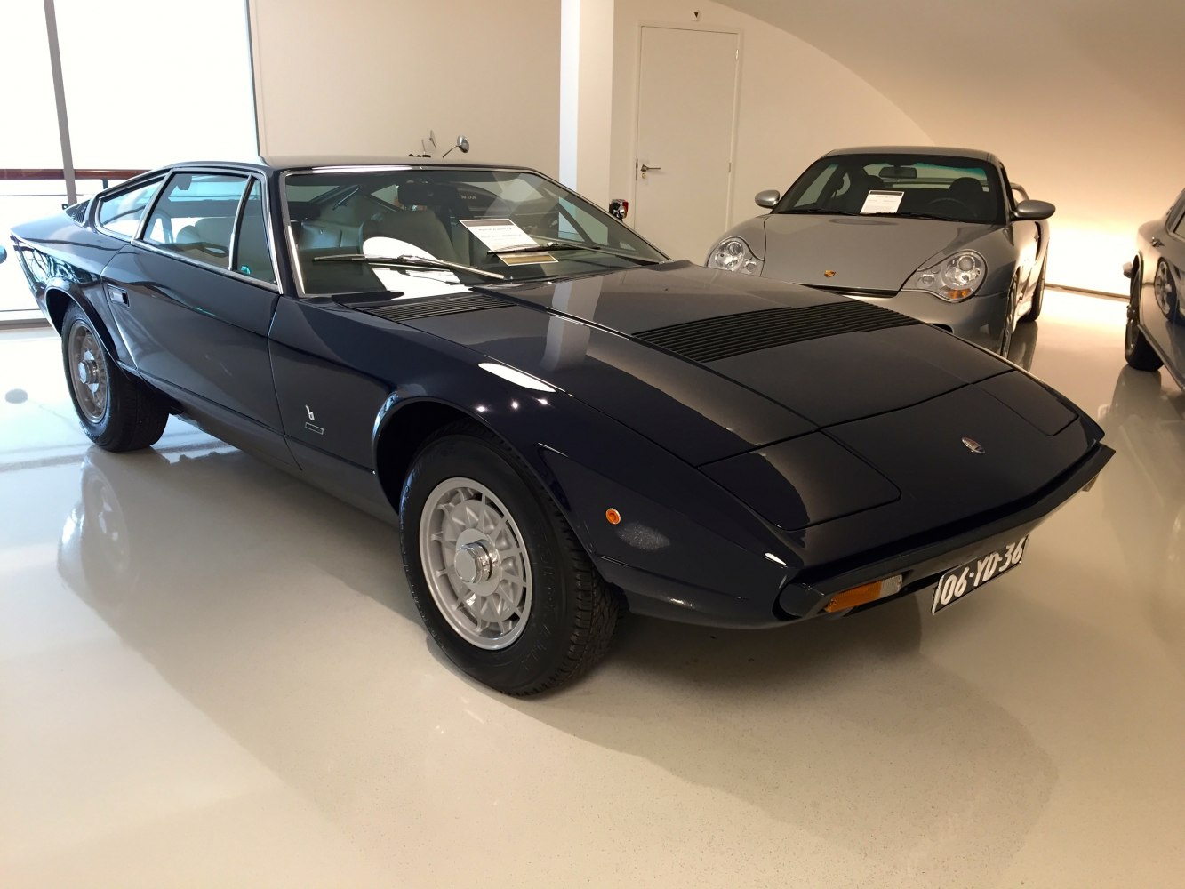 1970s sports coupe with pop-up headlights and mesh wheels