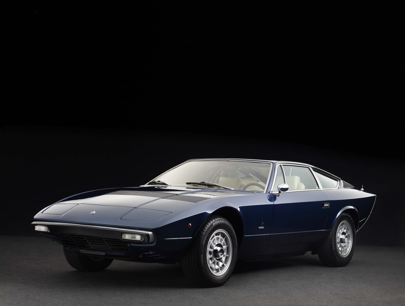 Sleek 1970s sports coupe front side profile, angular body, distinctive headlamps.