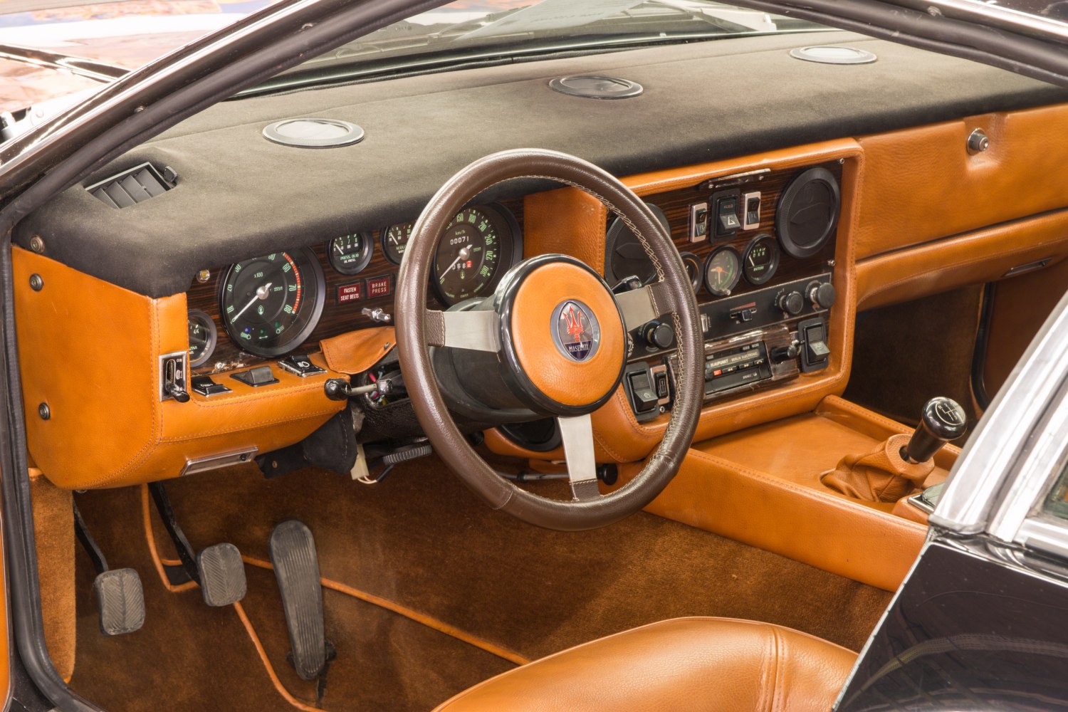 Vintage luxury car interior with leather upholstery and manual gearshift