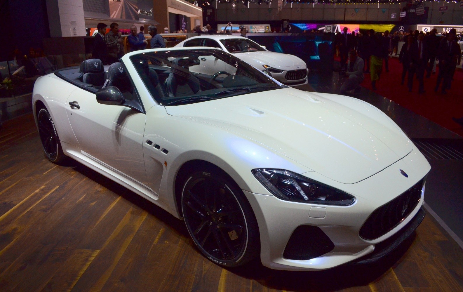 White convertible with black wheels and detailed front grille
