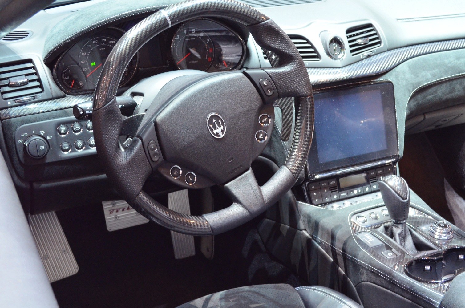 Carbon fiber steering wheel and center console with digital touchscreen and control buttons