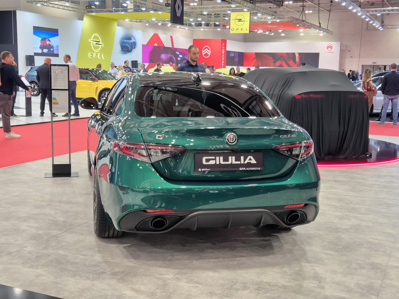 Rear view of a sporty sedan with distinct taillights and dual exhausts.
