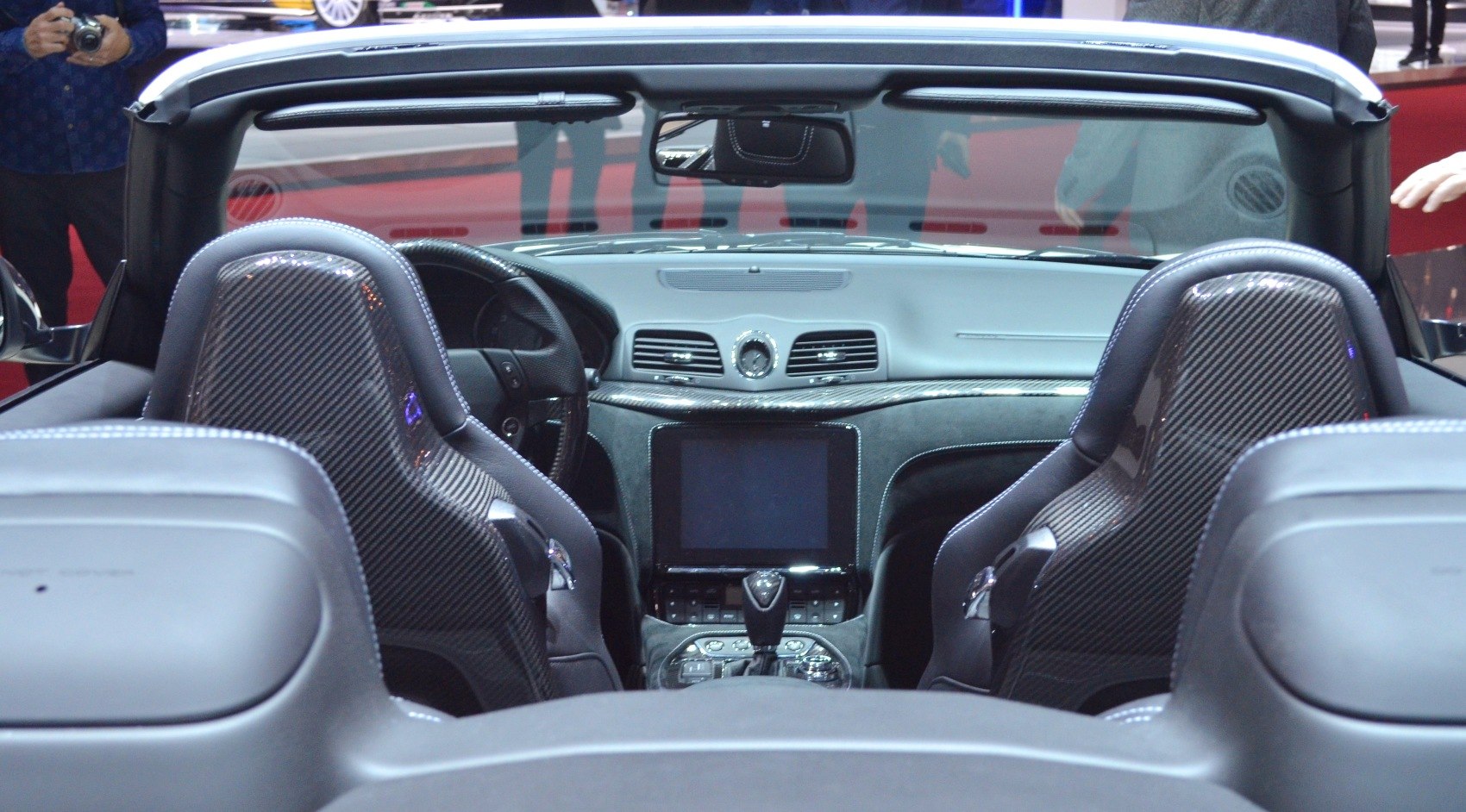 Carbon fiber racing seats and modern dashboard in a convertible interior