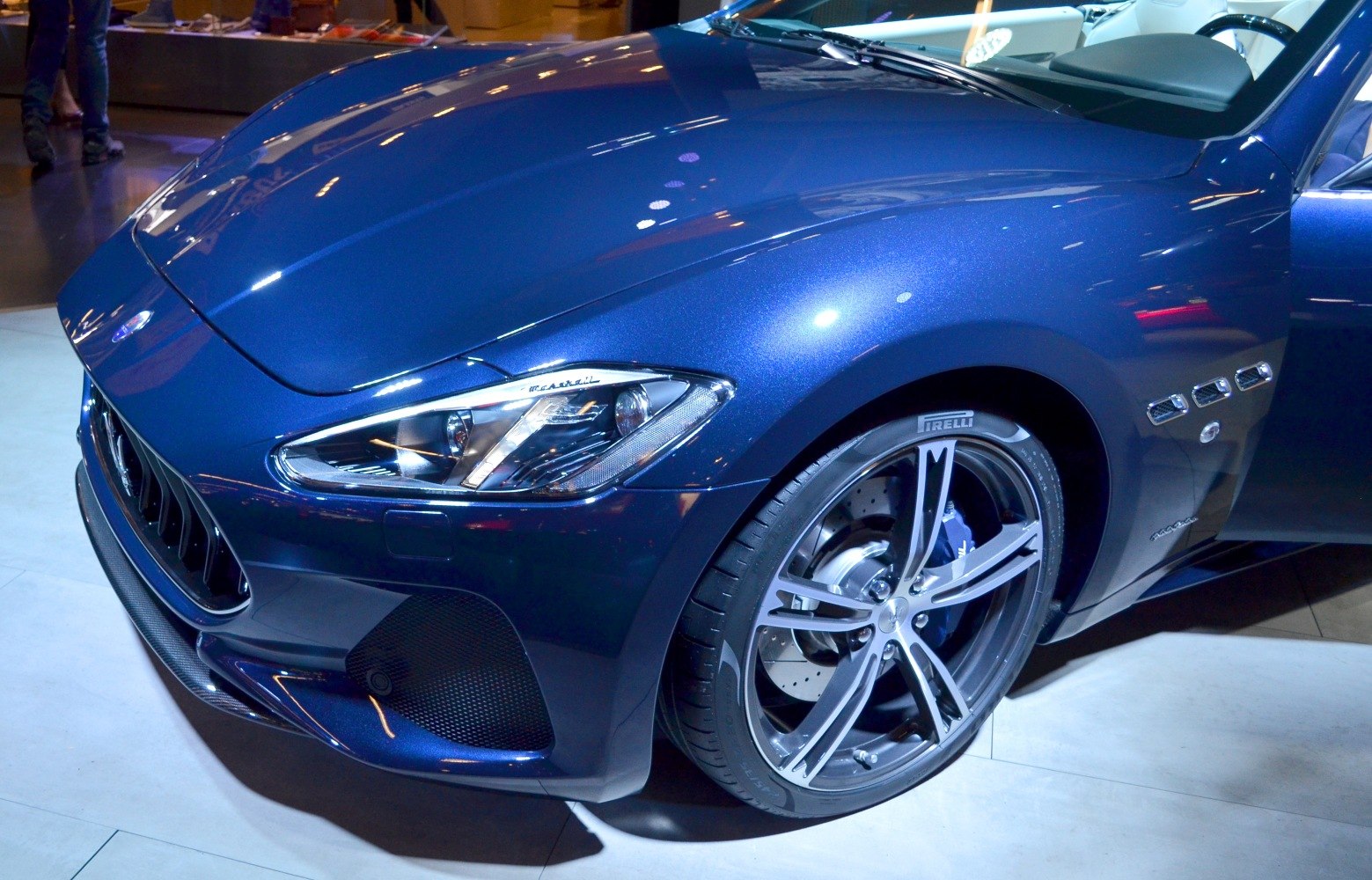 Close-up on front end with headlight and alloy wheel design