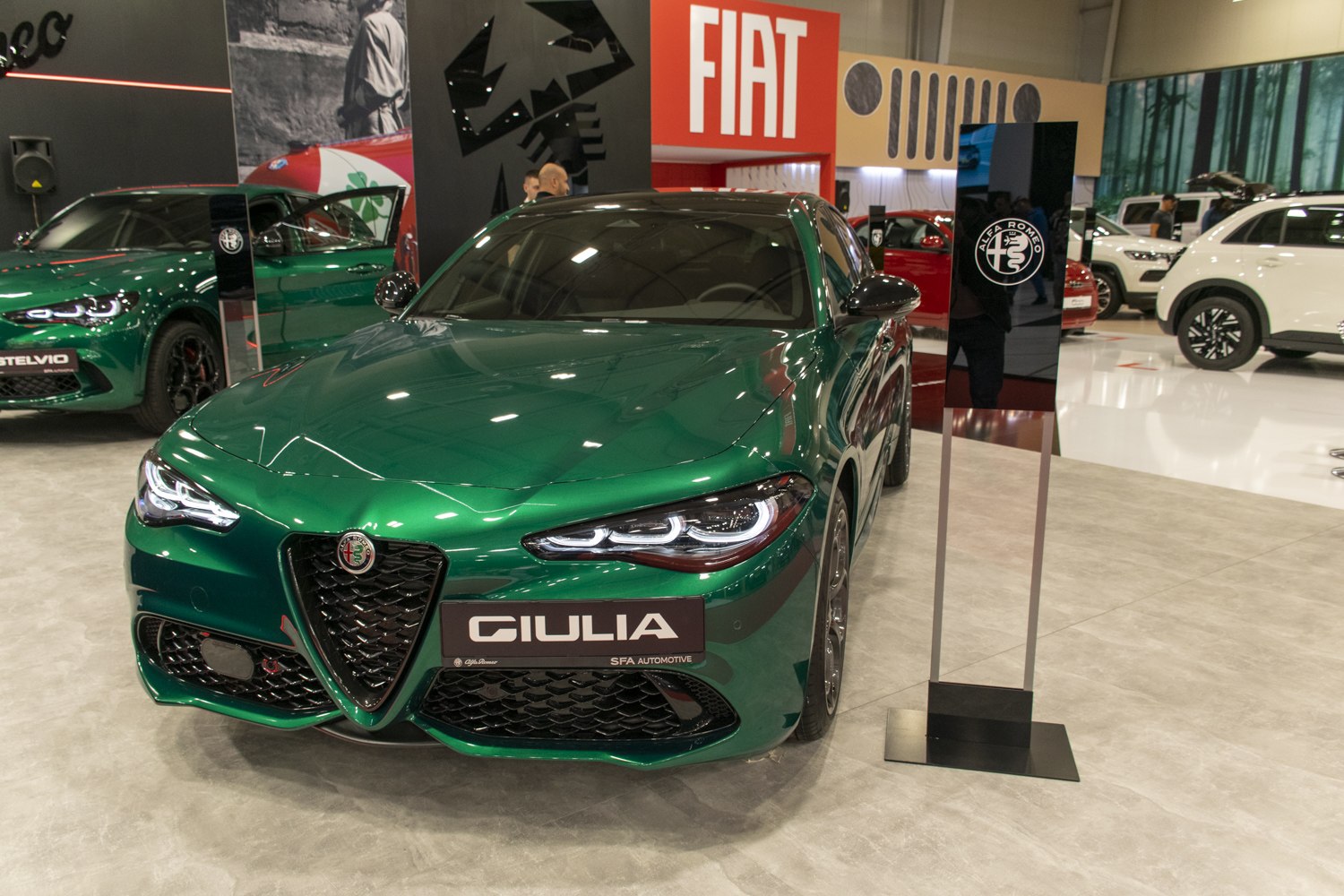 Green sport sedan with distinct LED headlights and triangular grille