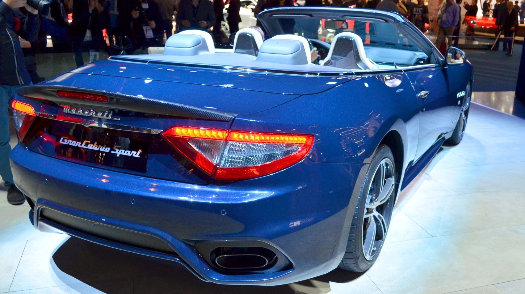 Convertible rear view with illuminated taillights and dual exhausts