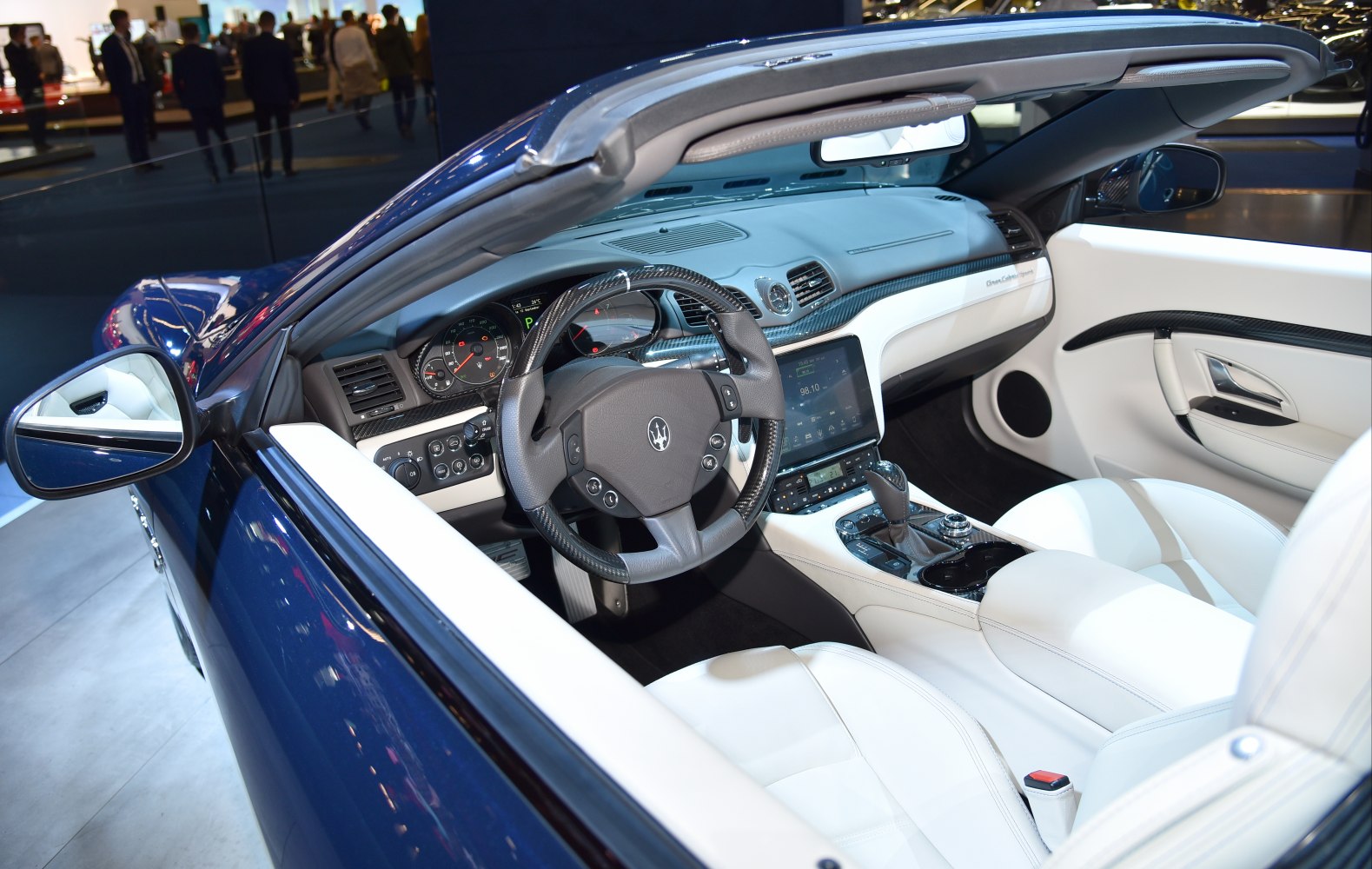 Convertible interior with carbon fiber steering wheel and white leather seats