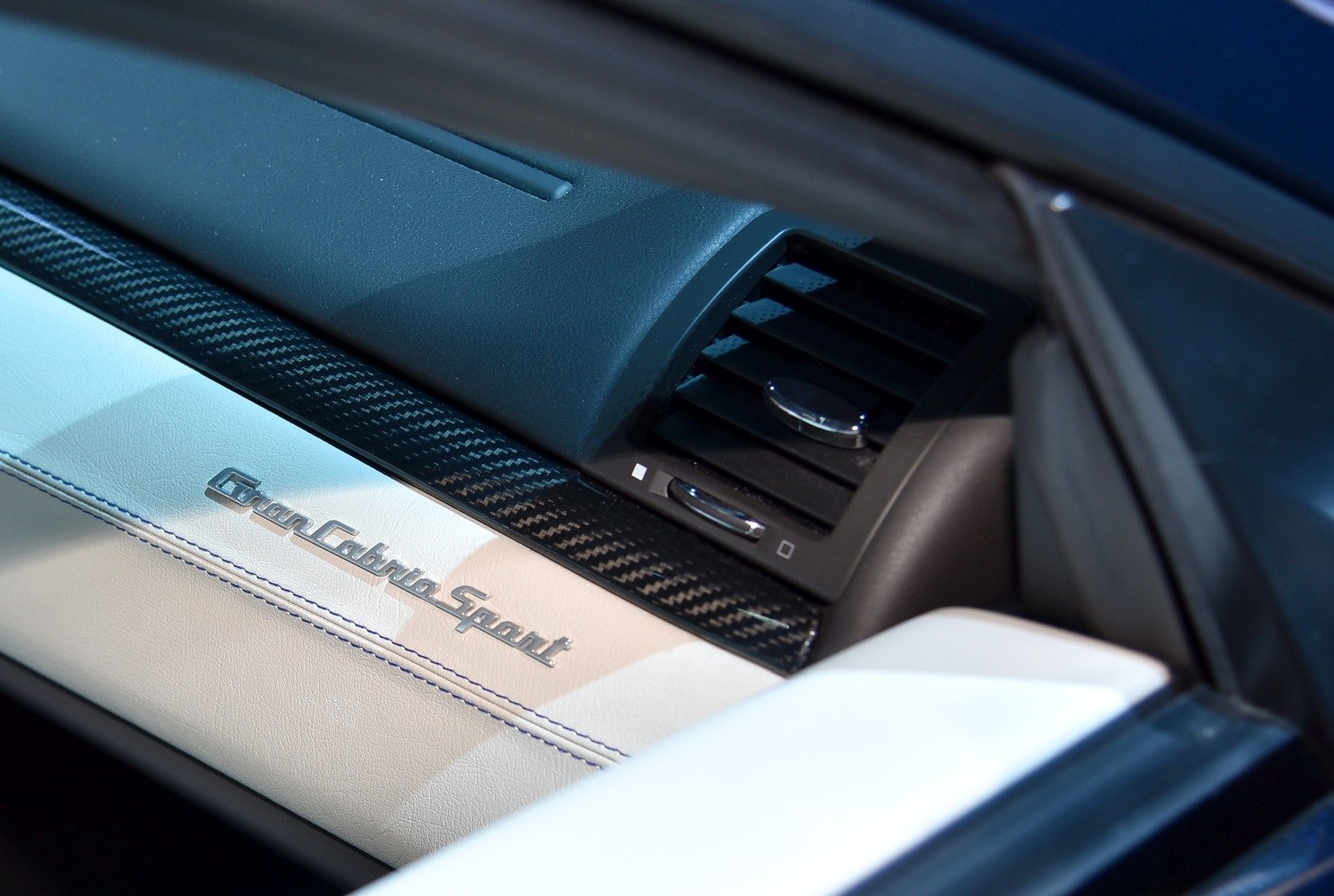 Interior showcasing carbon fiber trim and GranCabrio Sport emblem