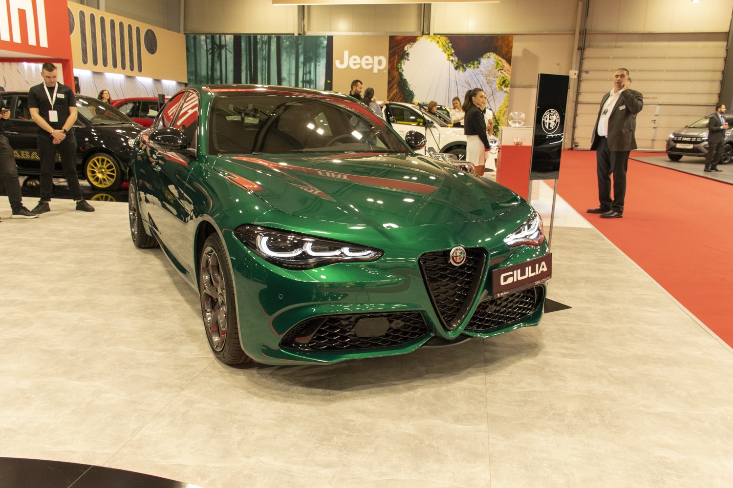 Glossy green sports sedan front with distinct grille and LED headlights