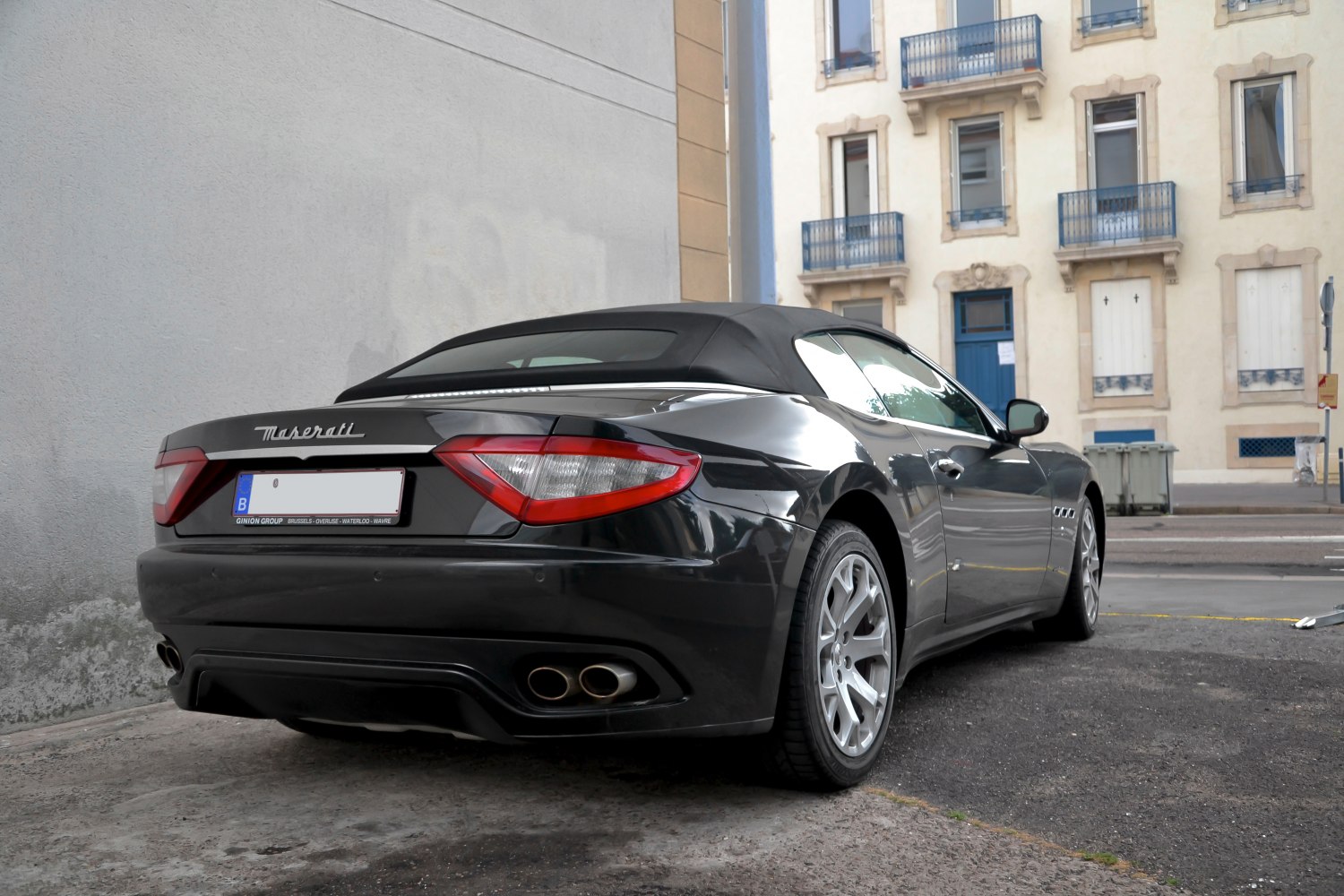 Rear view of a convertible with distinctive taillights and dual exhaust pipes