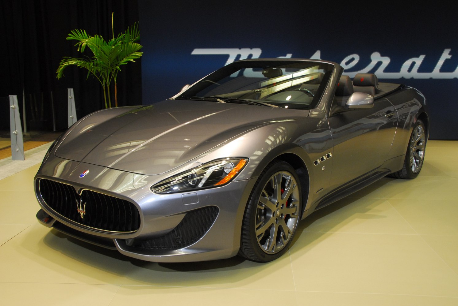 Convertible sports car front with prominent grille and alloy wheels