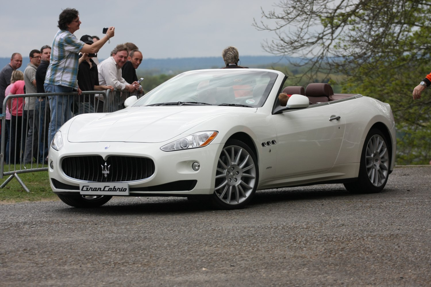 White convertible with distinct front grille and alloy wheels