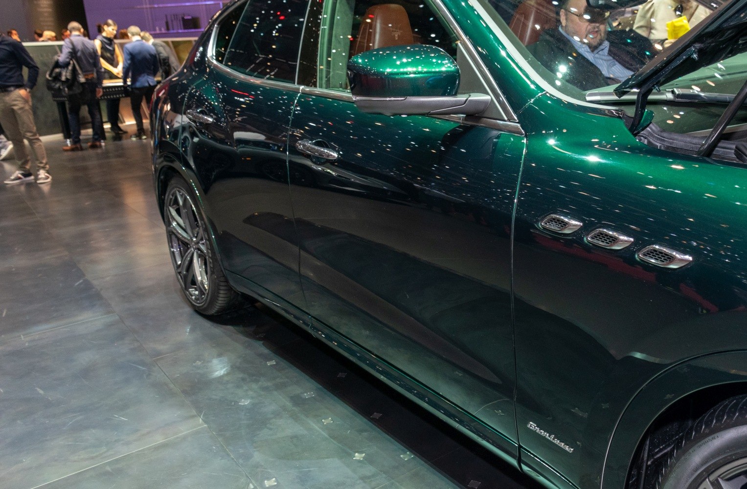 Close-up of side panel with triple vents and wheel of a luxury SUV