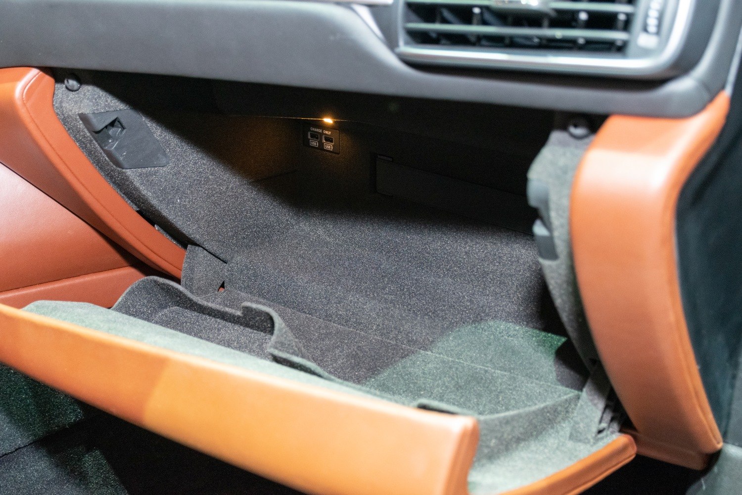 Car glove compartment interior with USB charging ports and brown trim