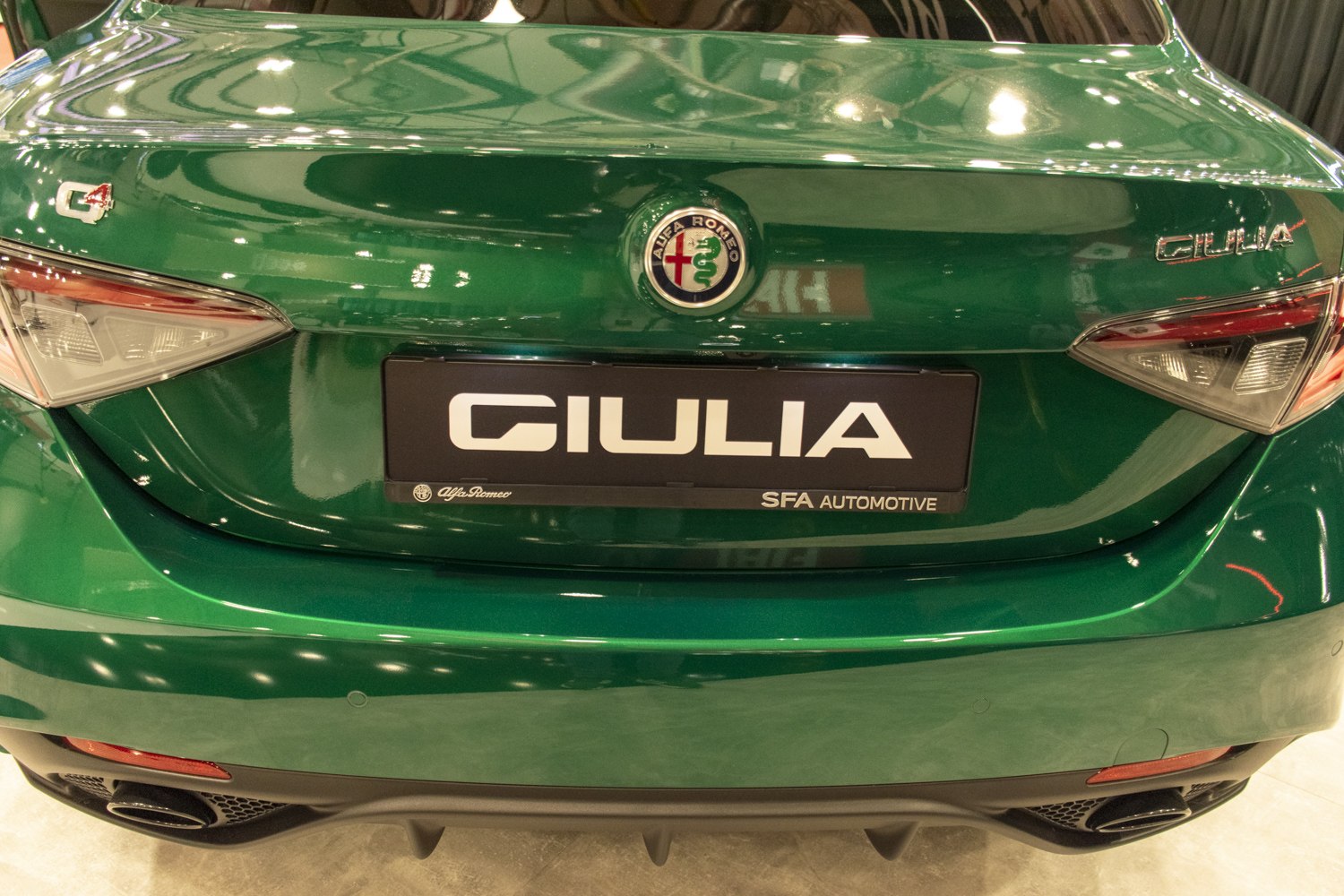Rear end view with taillights, badges, and dual exhausts