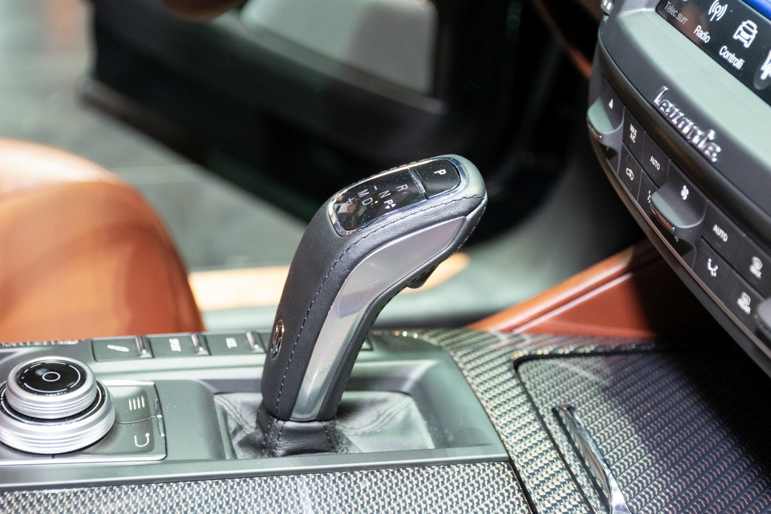 Gear shifter and center console with carbon fiber trim in luxury SUV