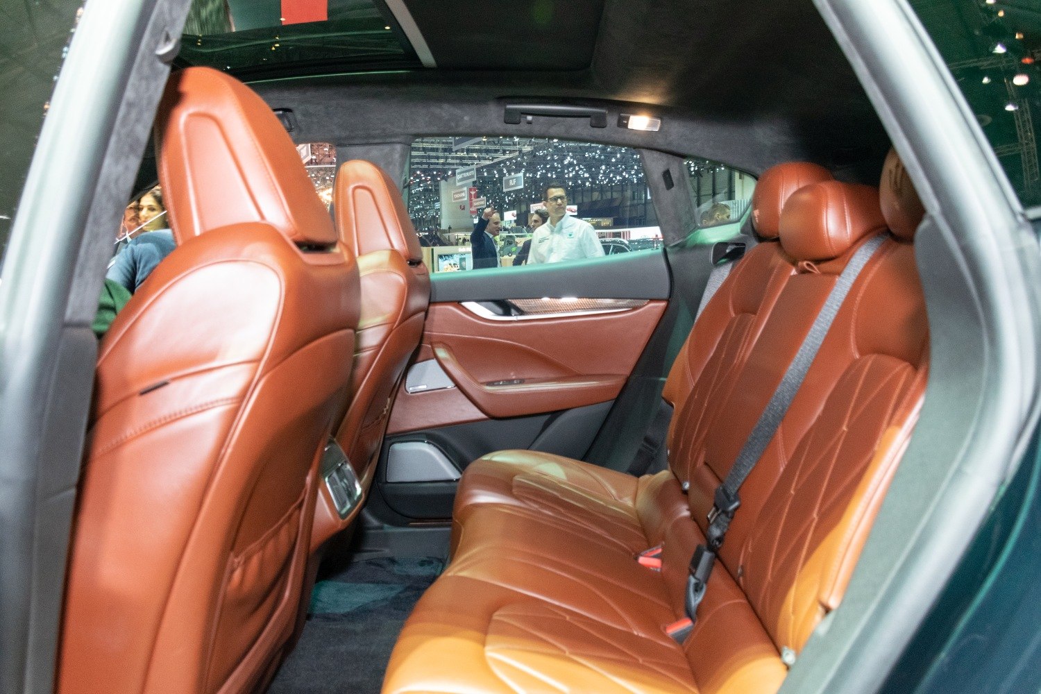 Brown leather rear seats with detailed stitching in spacious SUV interior