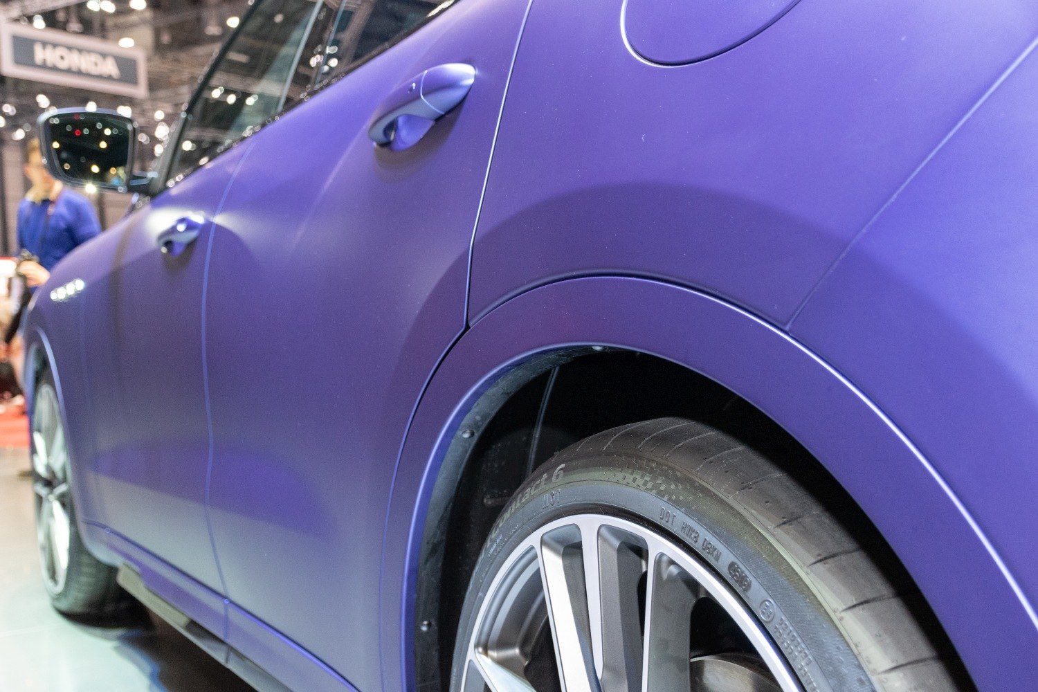 Matte purple SUV side door and alloy wheel close-up