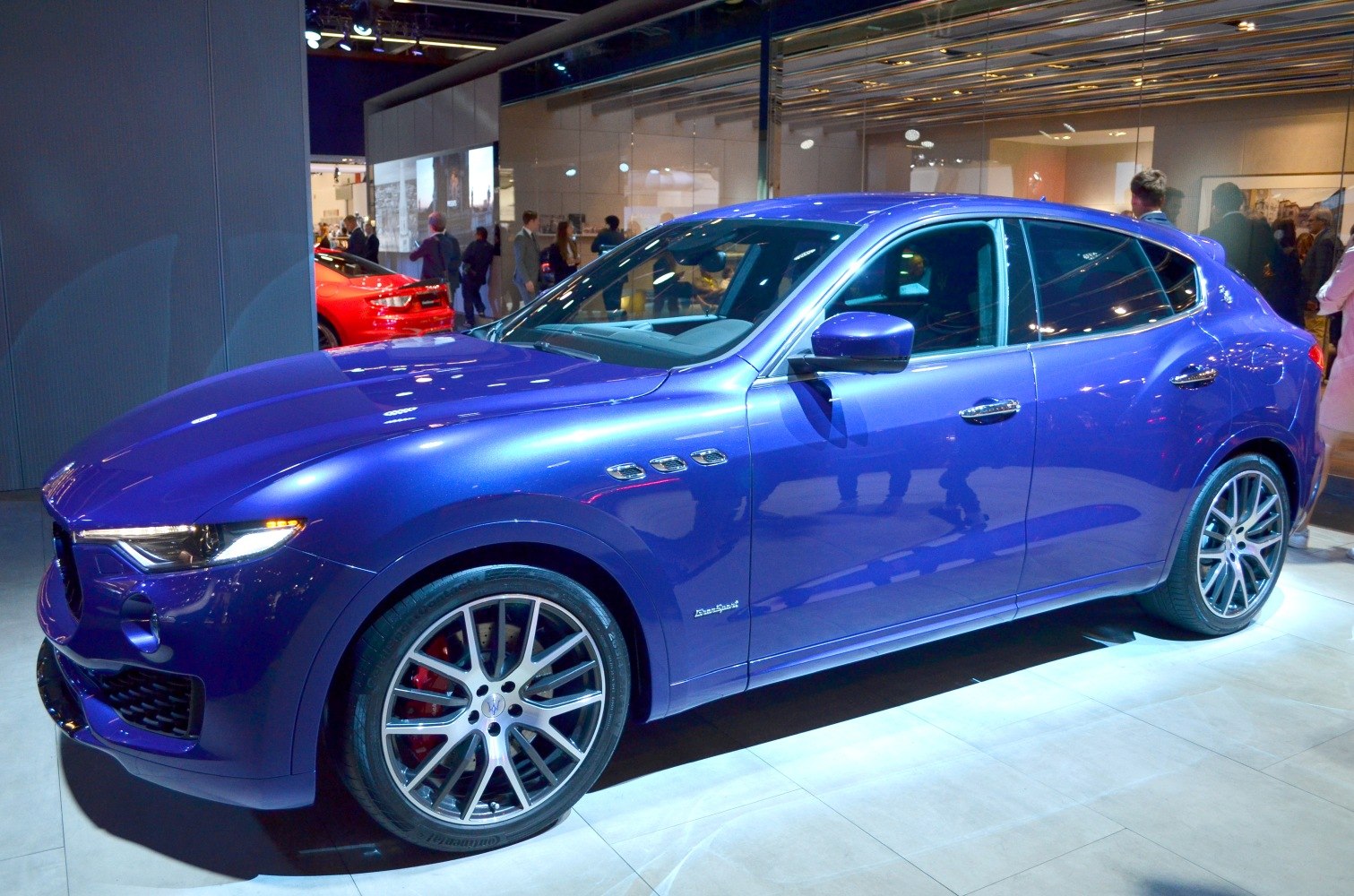 Blue SUV with multi-spoke alloy wheels and side air vents