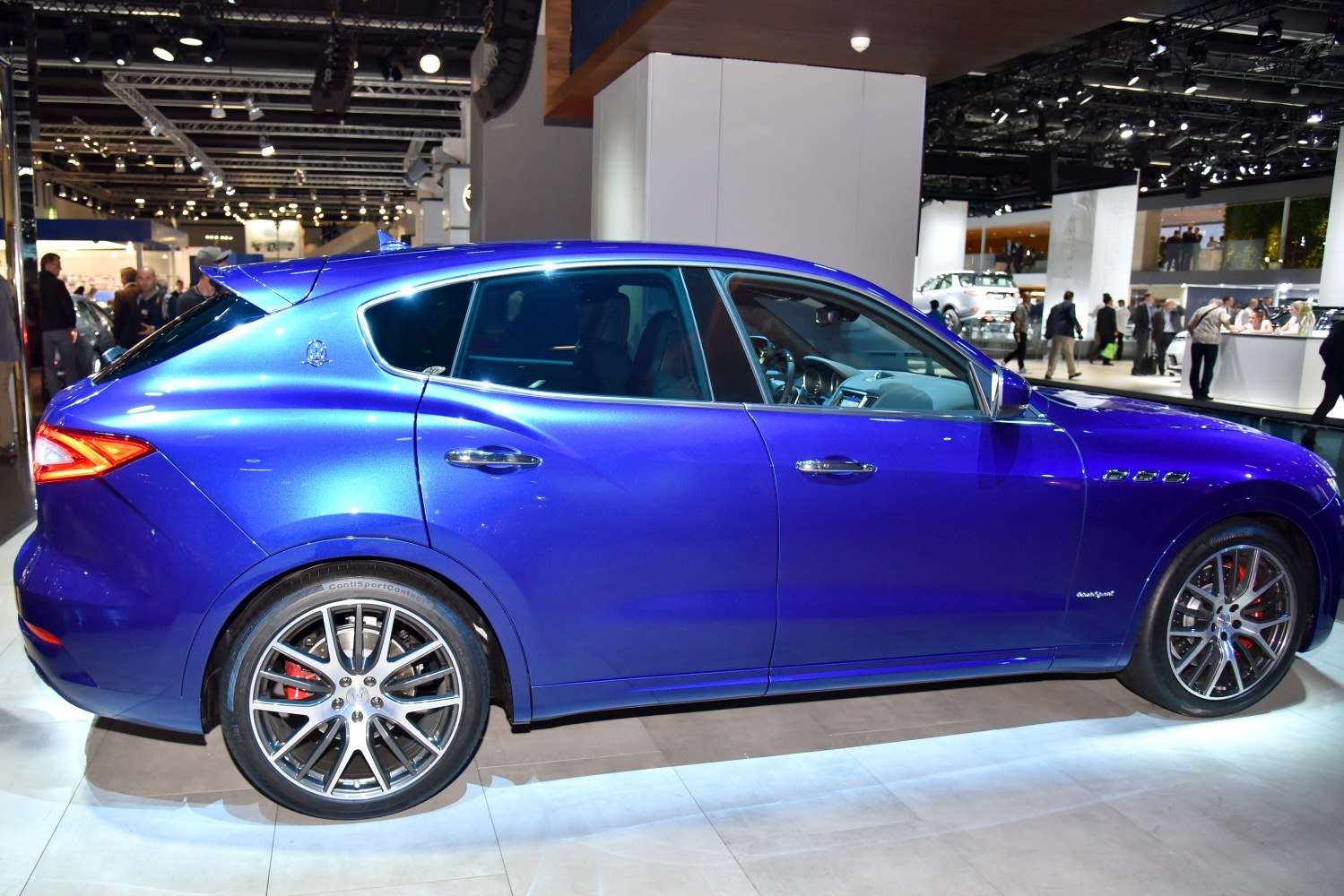 Side profile focusing on aerodynamic body and distinctive alloy wheels.