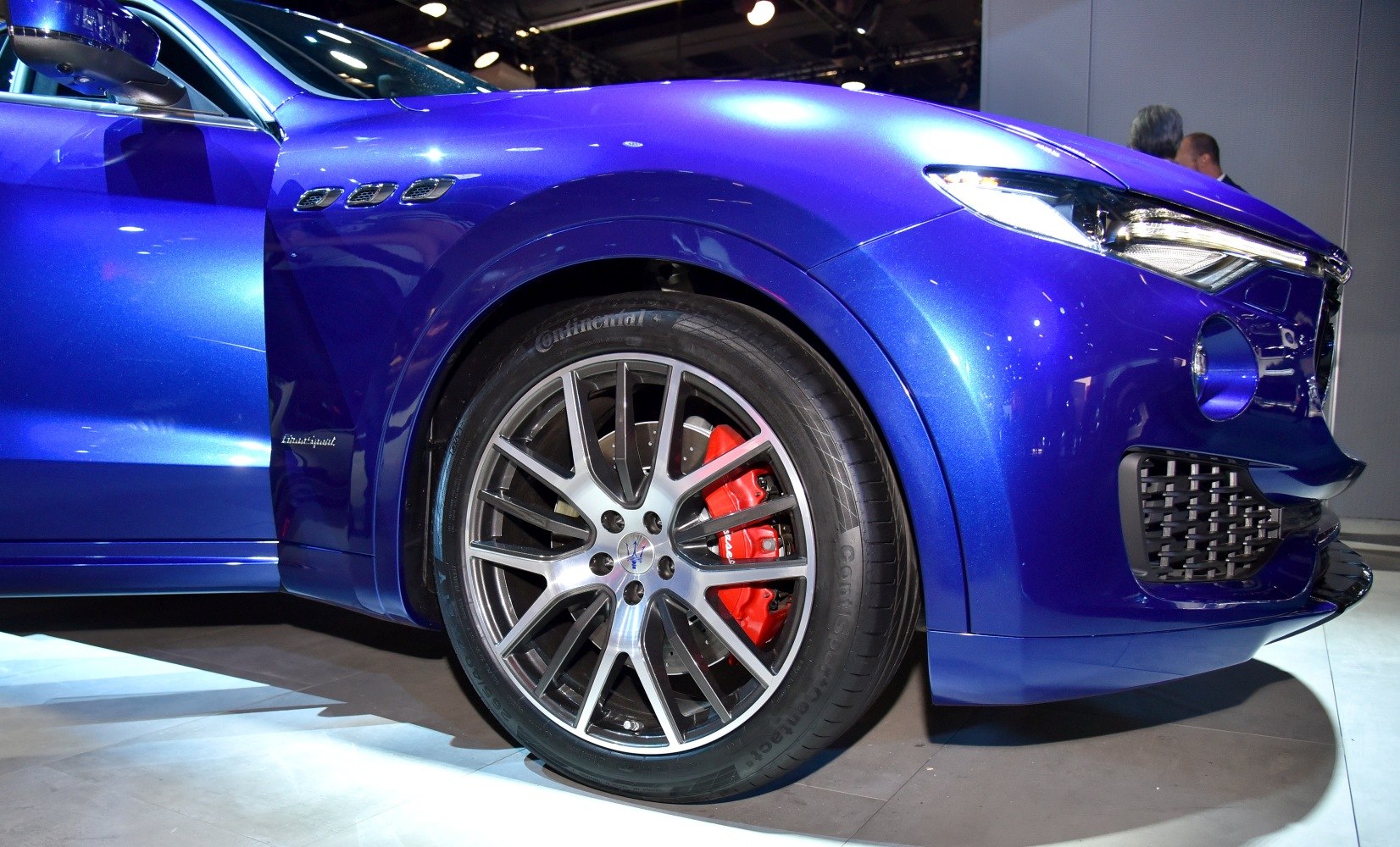 Sporty alloy wheel with red brake caliper and blue front fender detail