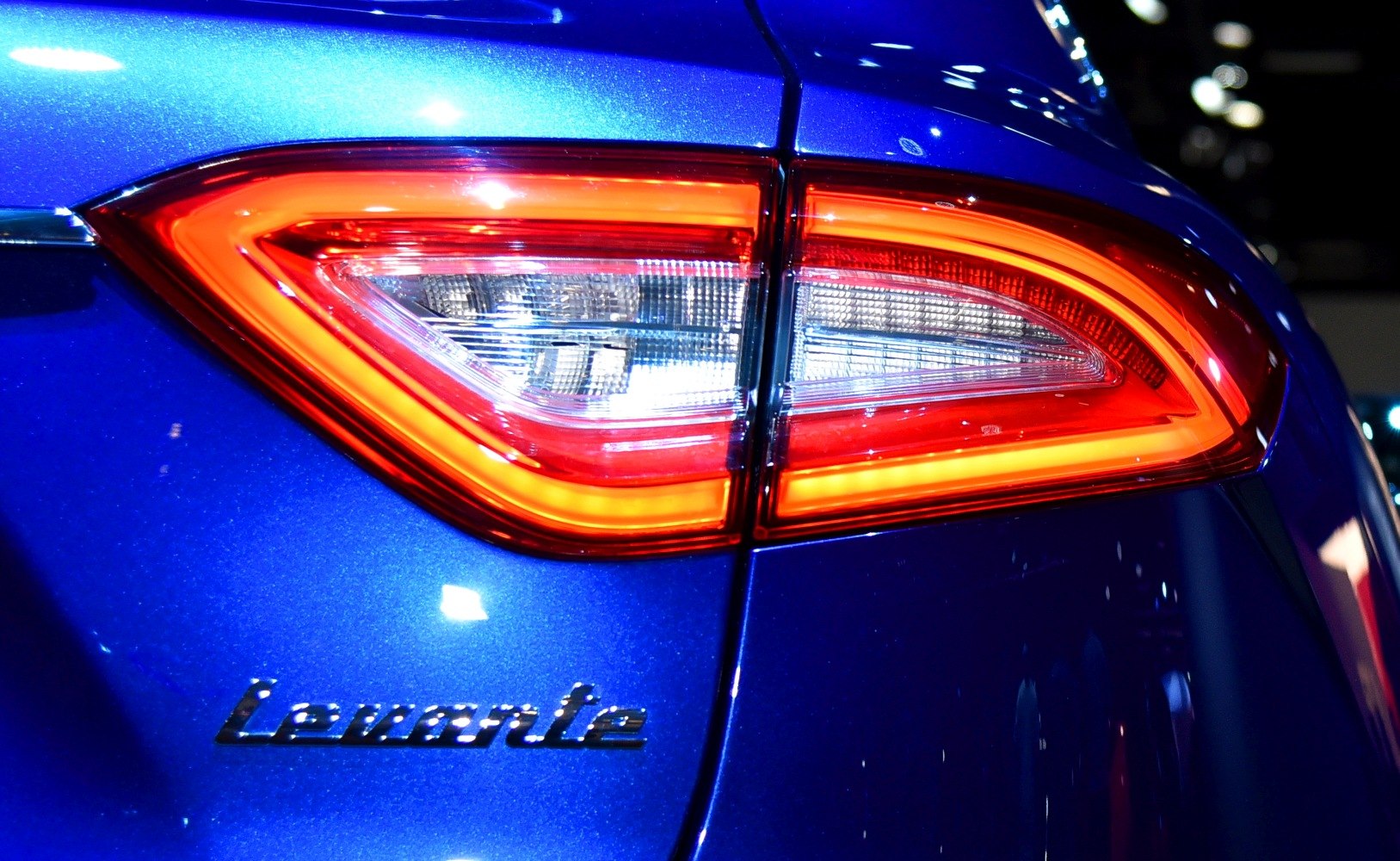 Close-up of LED rear tail light and Levante badge on blue vehicle surface