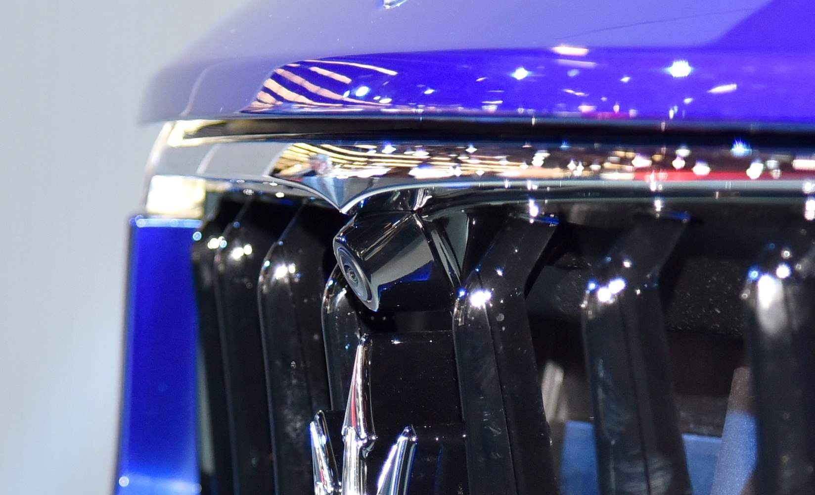 Front grille with embedded camera and chrome trim