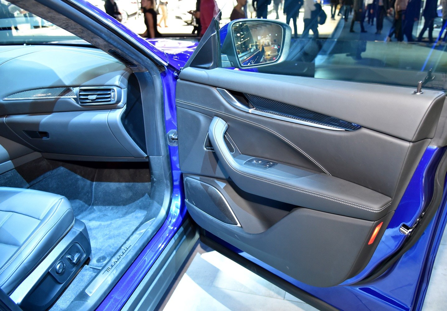 Front interior door panel and passenger seat with luxury design and materials