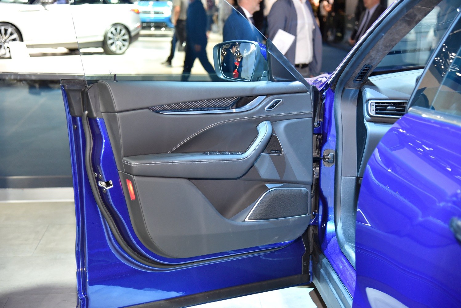 Luxury SUV interior door panel with controls and premium trim