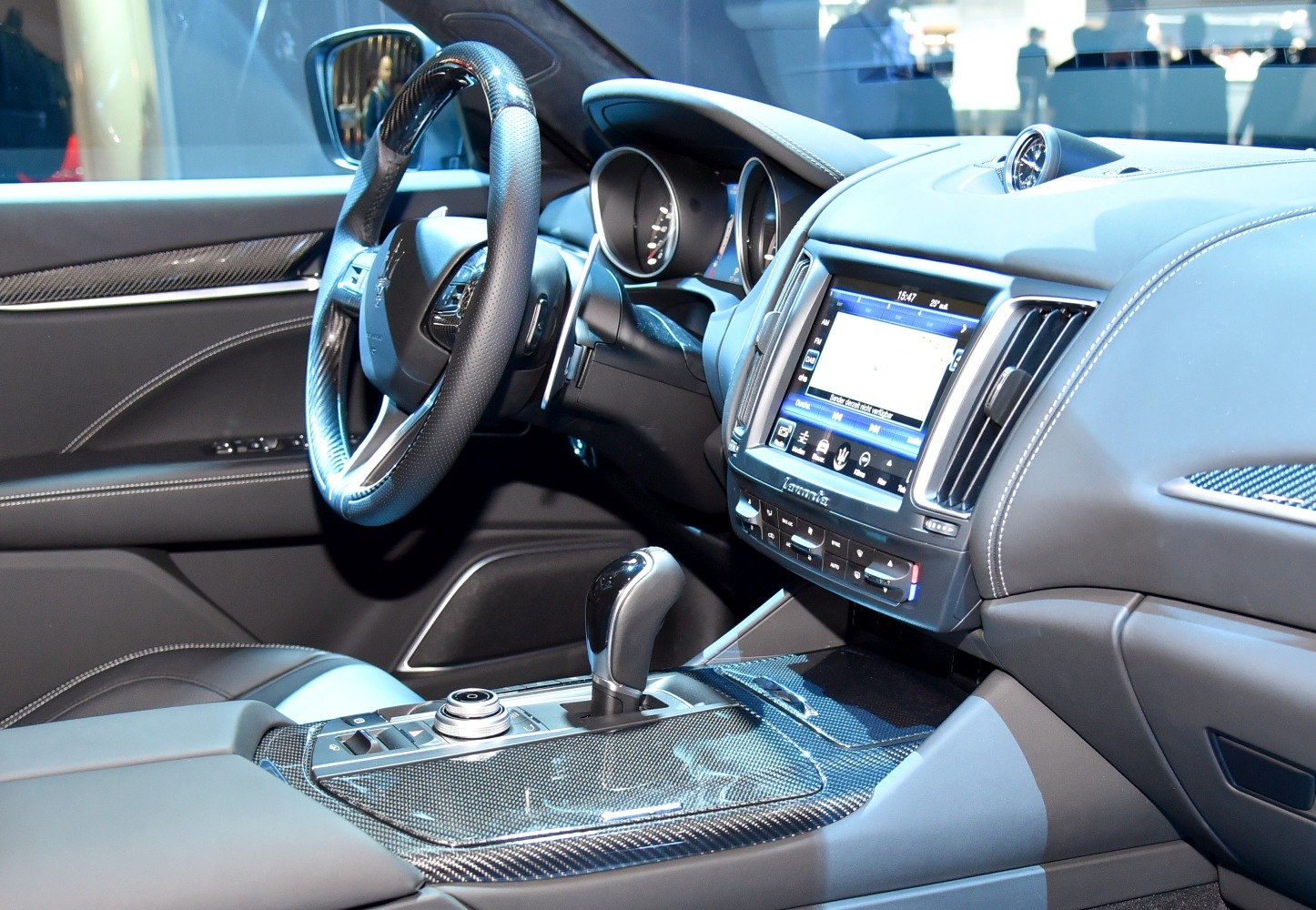 Carbon fiber center console and perforated leather steering wheel