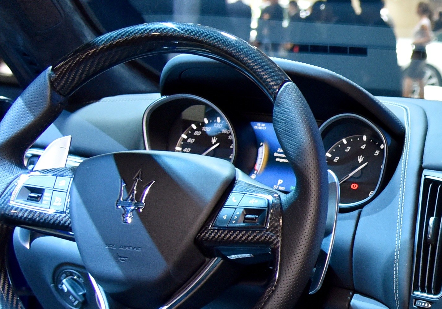Luxury steering wheel with carbon fiber trim and detailed instrument cluster