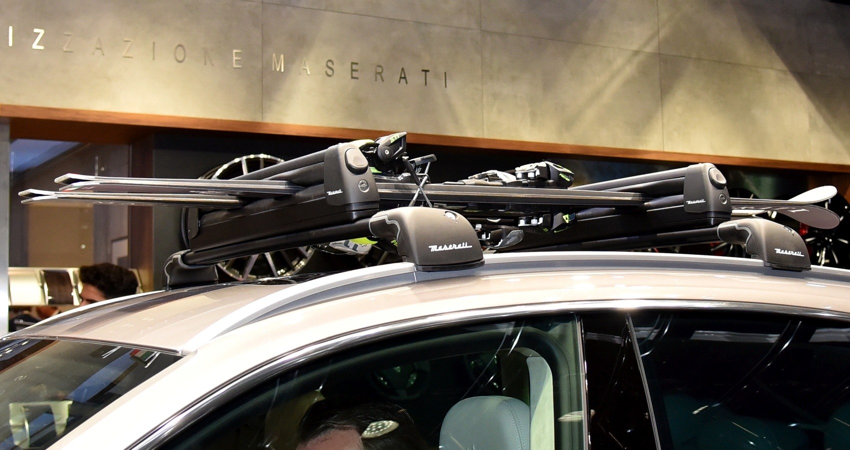 Roof mounted ski rack with skis on luxury SUV