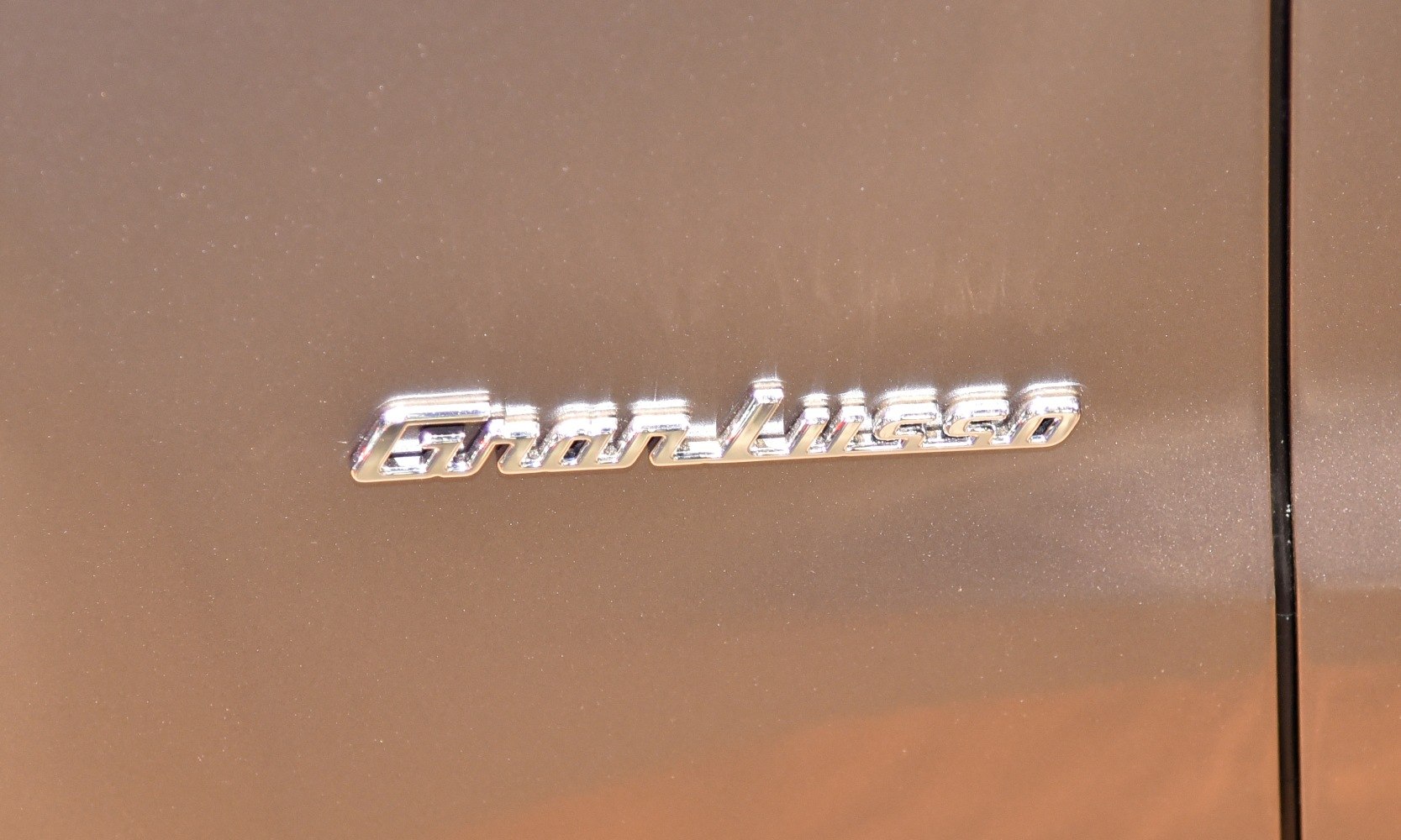 Close-up of GranLusso badge on car door
