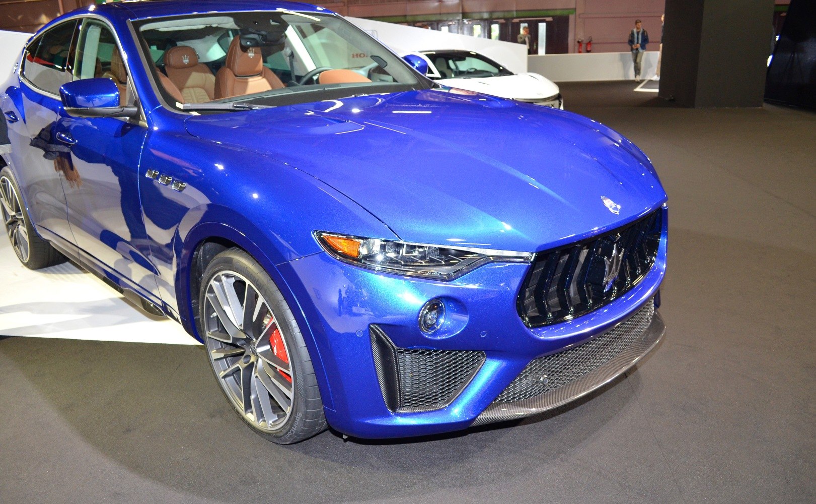 Front view of blue metallic SUV with alloy wheels and aggressive grille