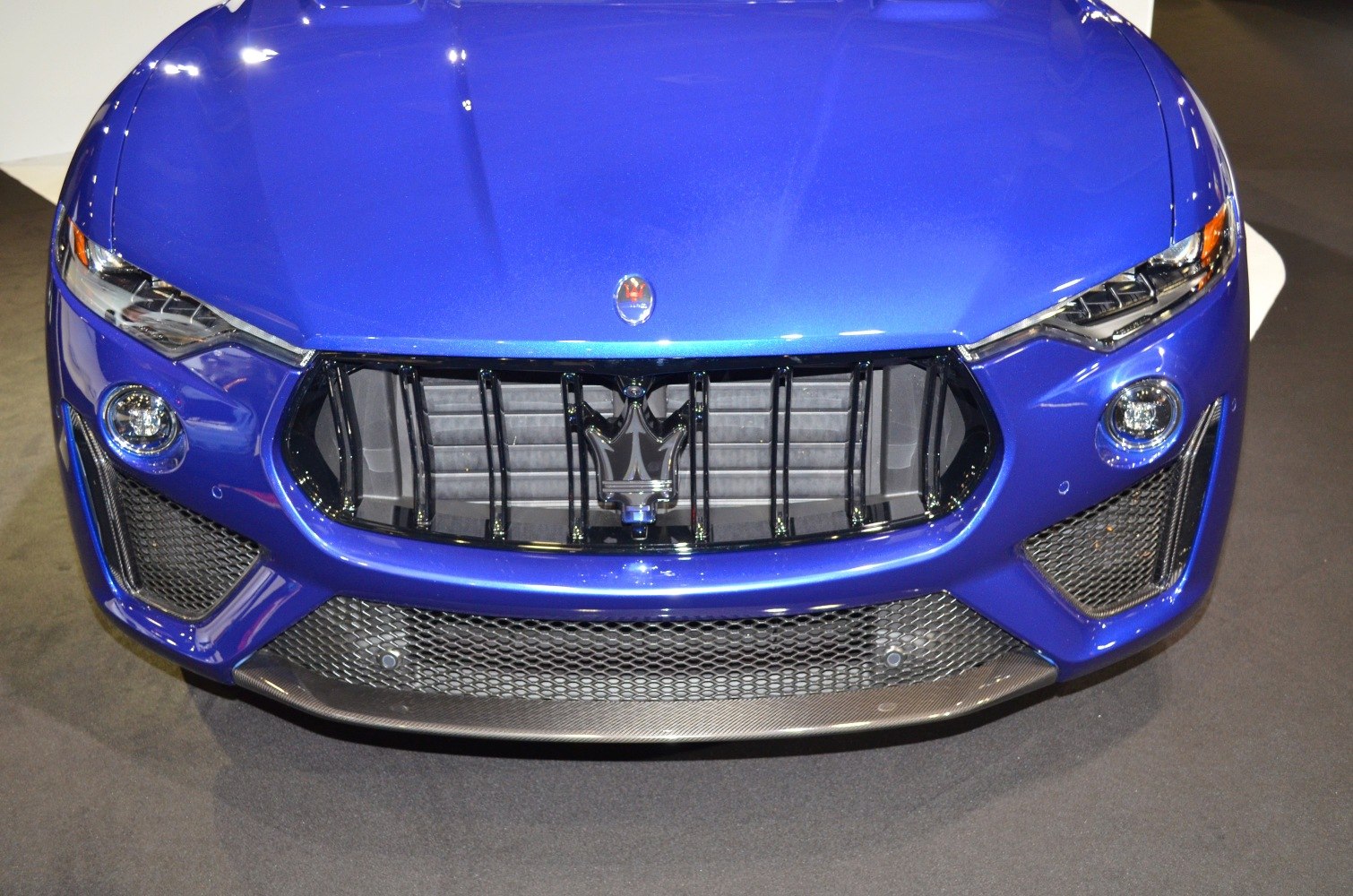 Front grille with emblem and detailed headlights of a luxury SUV