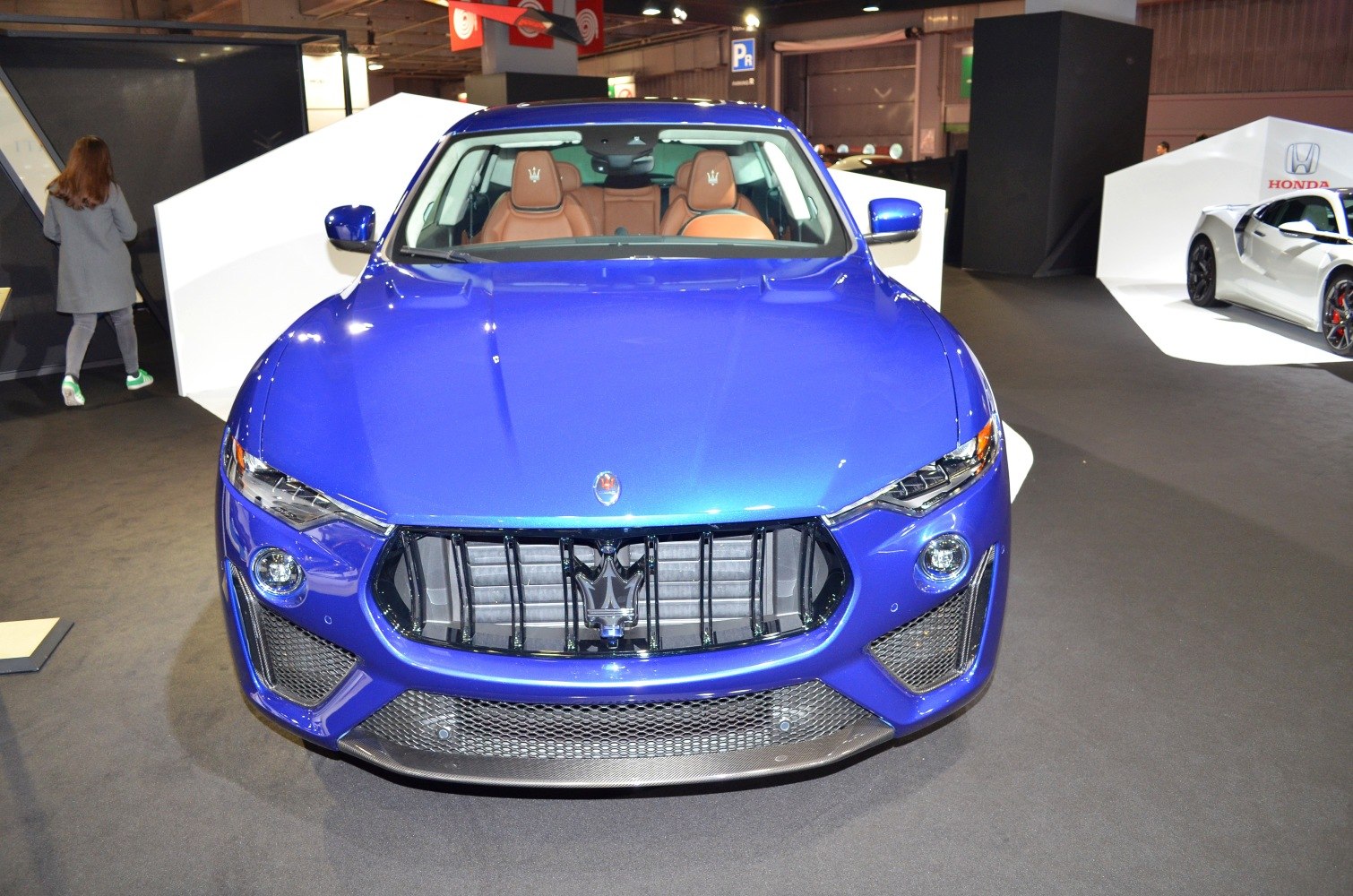 Front view of a blue luxury SUV with prominent grille and sleek headlights.