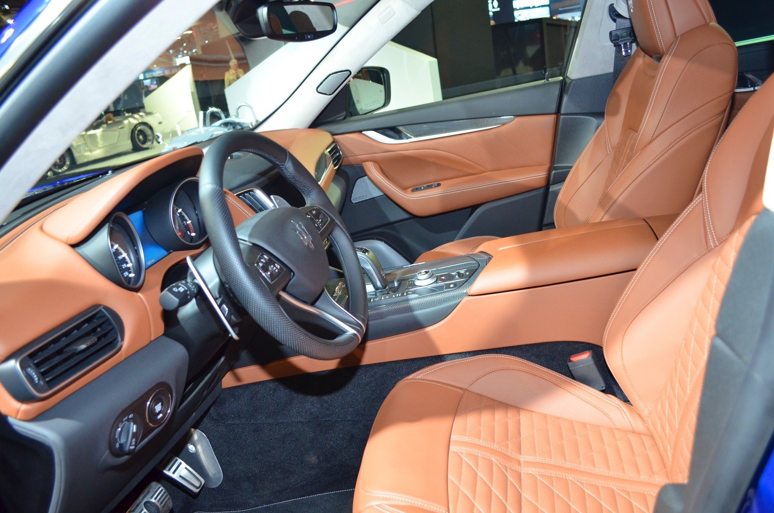 Tan leather seats and modern dashboard interior with center console and steering wheel