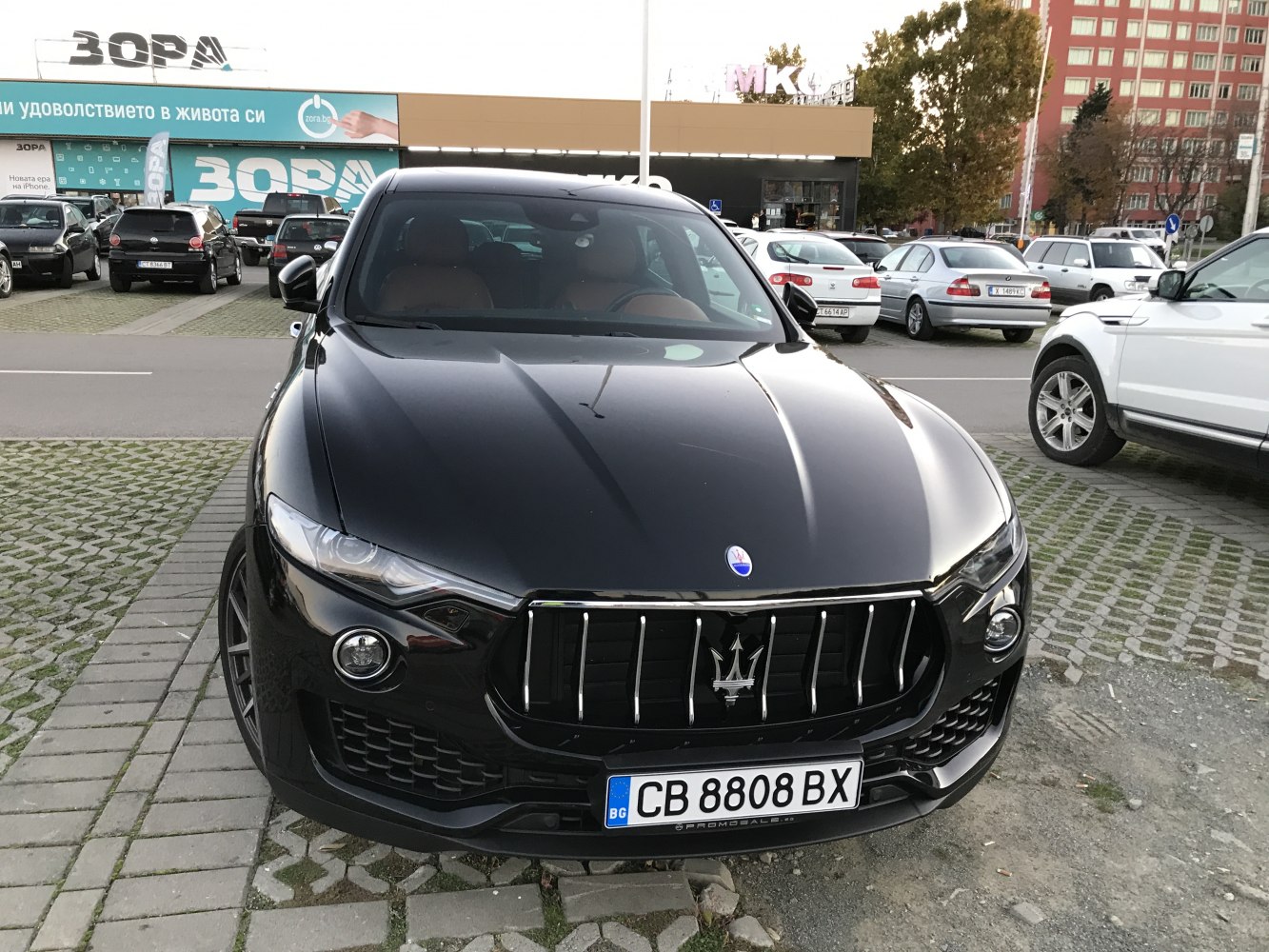 Front view focused on vertical grille and sleek headlights of luxury SUV