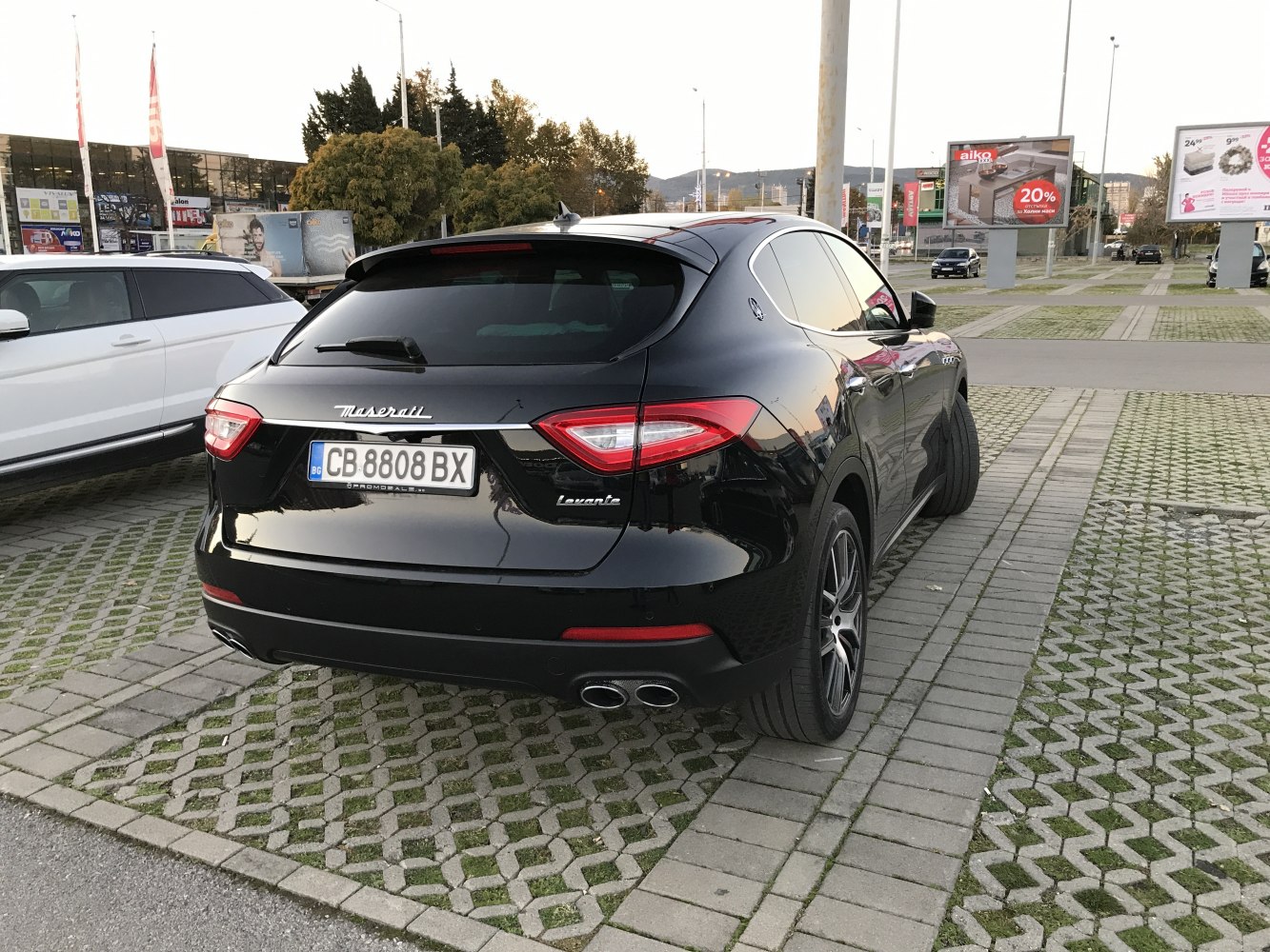 Rear view with dual exhaust, tinted windows, and sleek taillights.