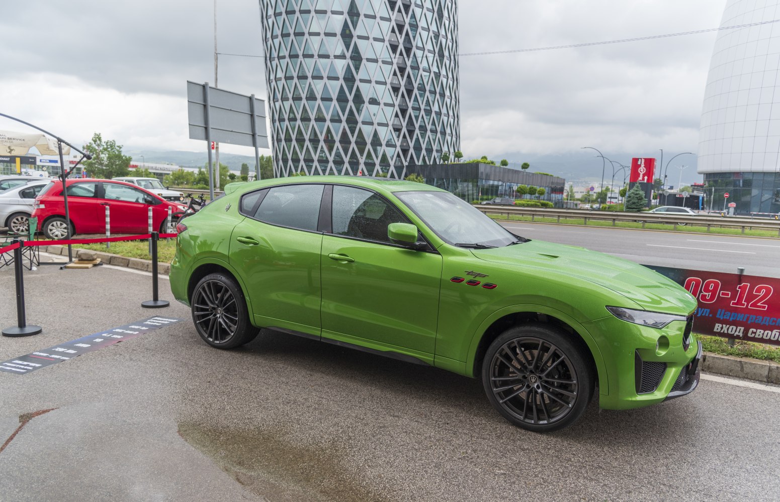Green luxury SUV with black alloy wheels and side vents